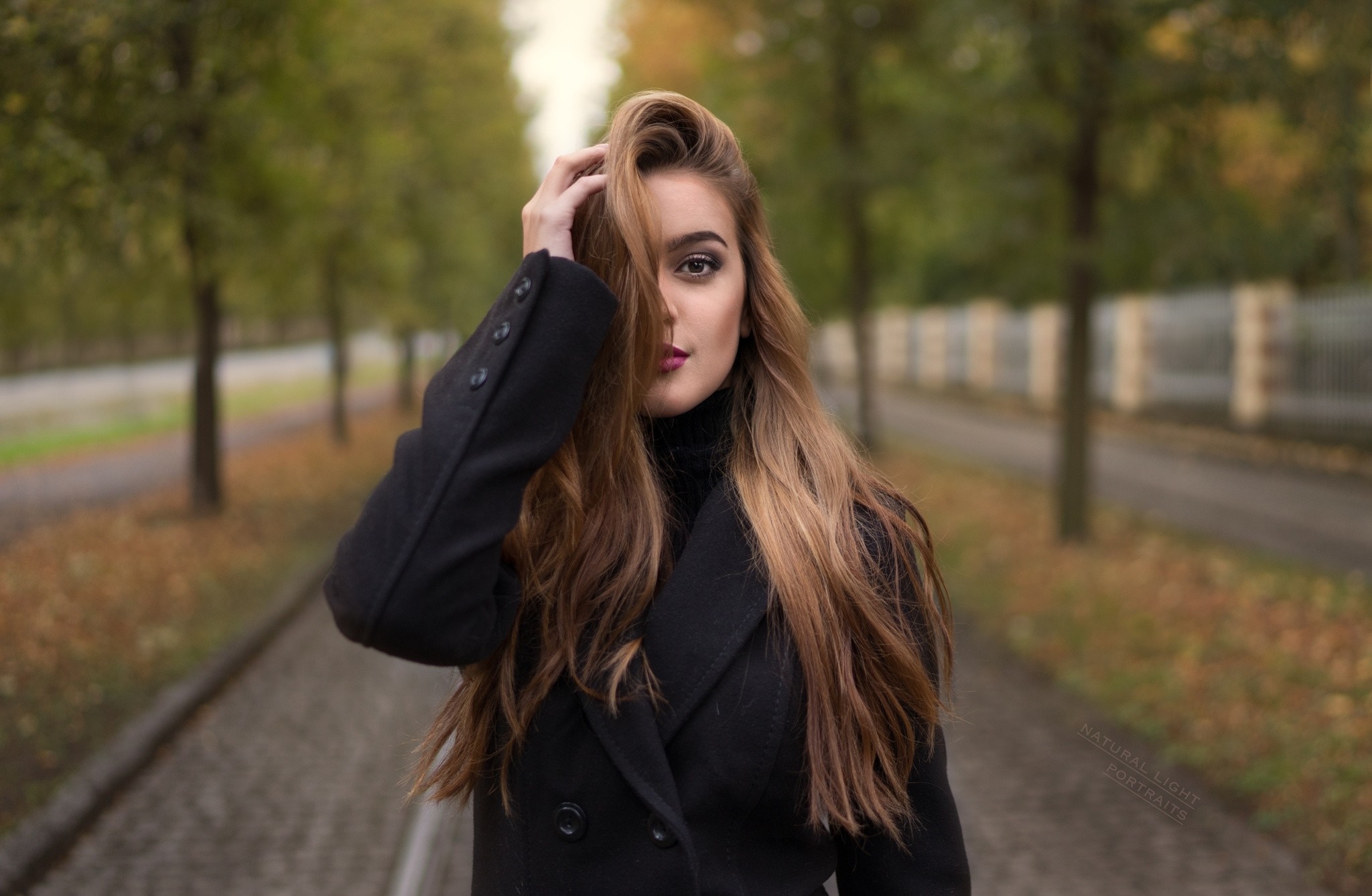 Woman with long brown hair in a black coat HD Wallpaper