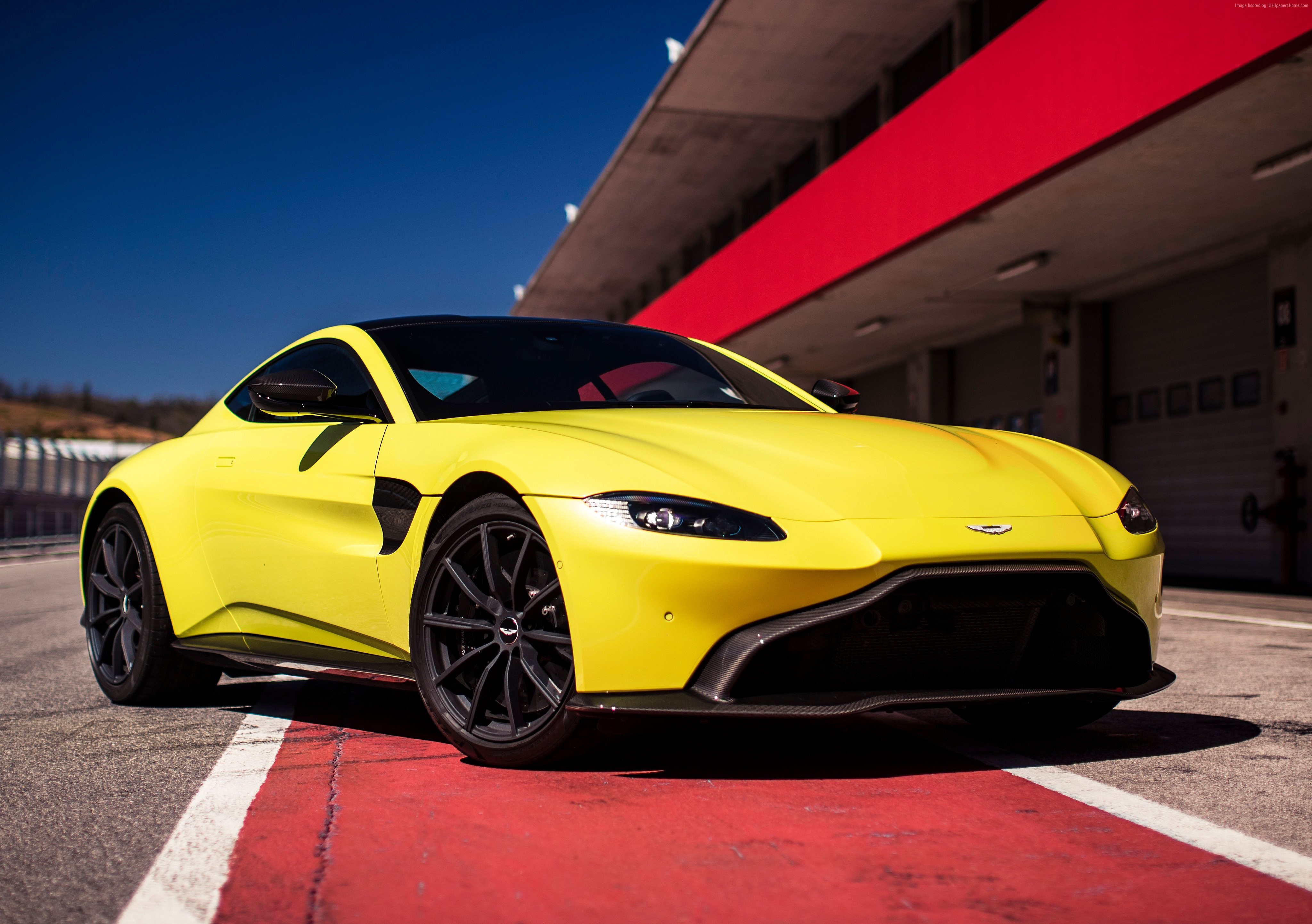 Yellow Aston Martin Vantage on a Racetrack HD Wallpaper