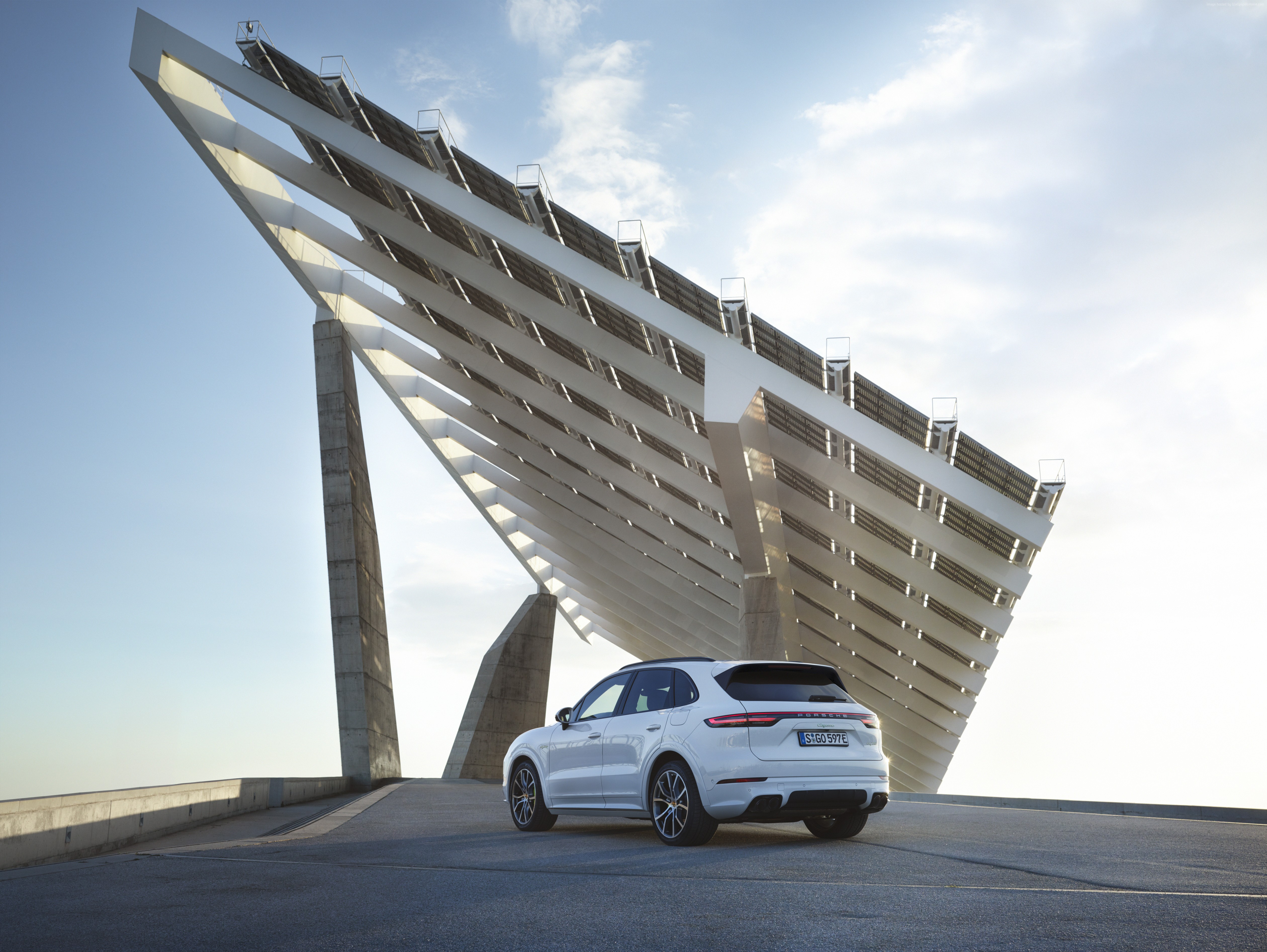 White Porsche Cayenne E-Hybrid SUV near solar panels HD Wallpaper