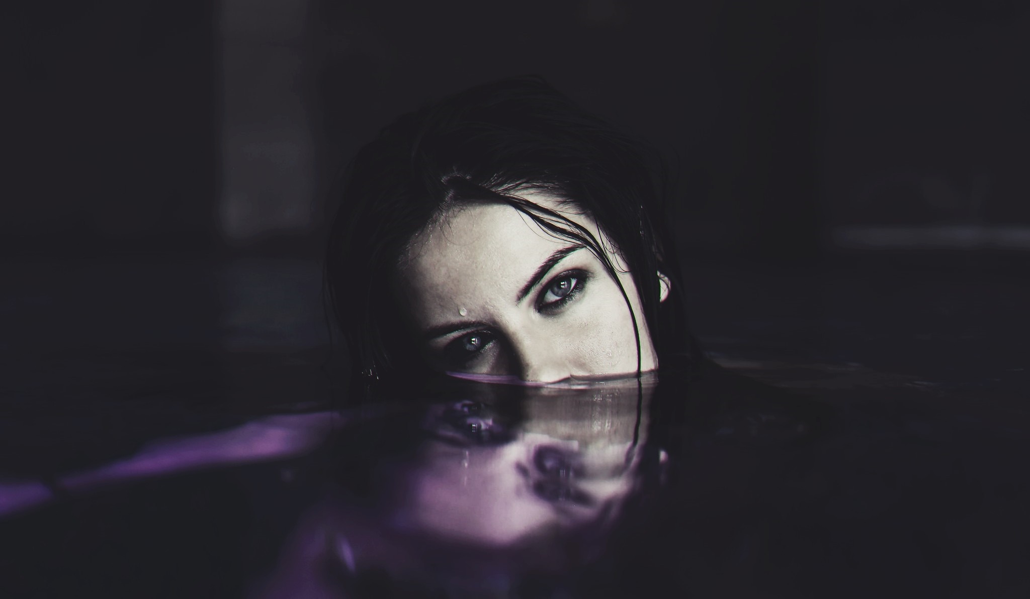 Portrait of a woman emerging from dark water HD Wallpaper