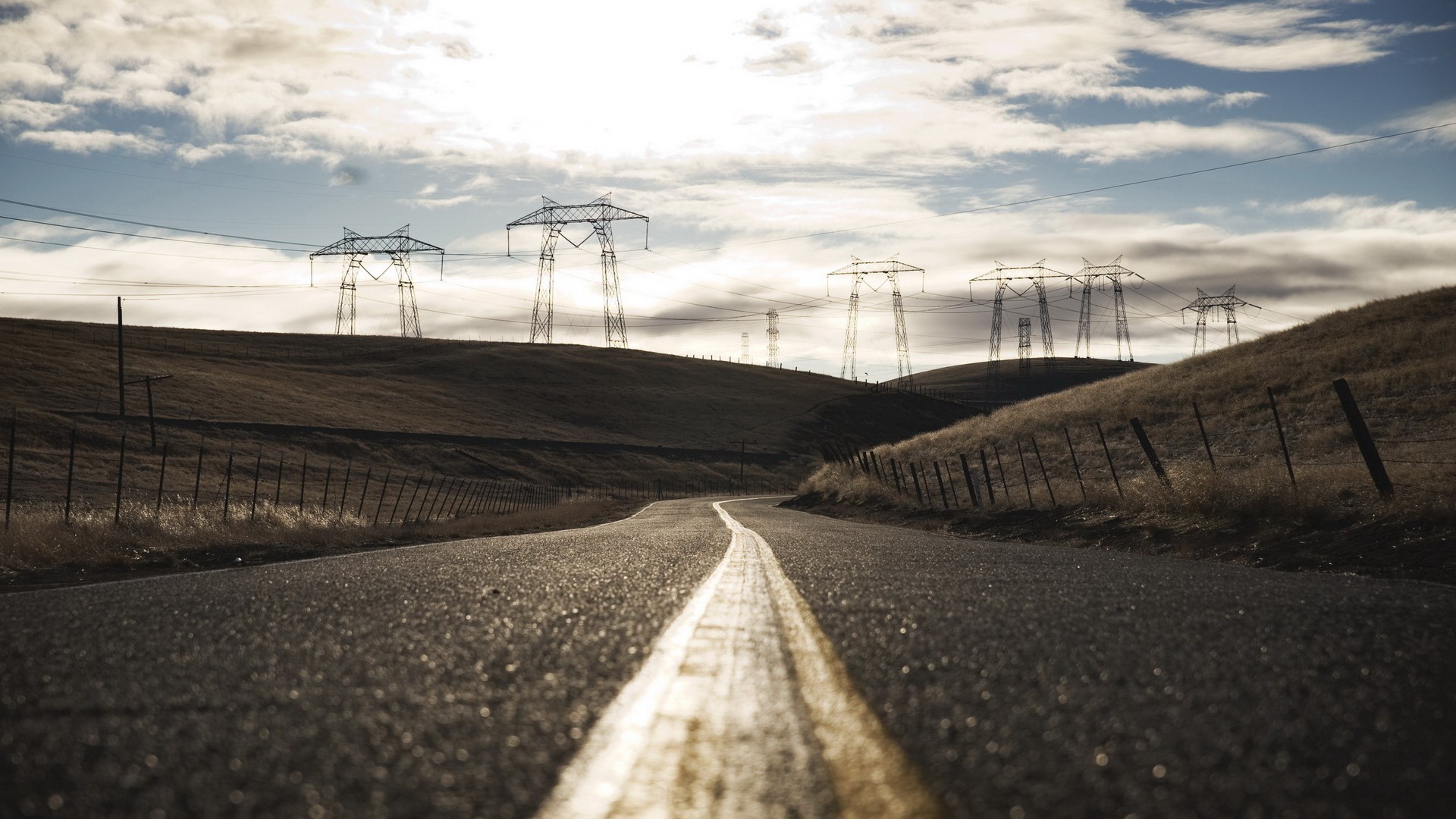 Road with power lines and hills HD Wallpaper