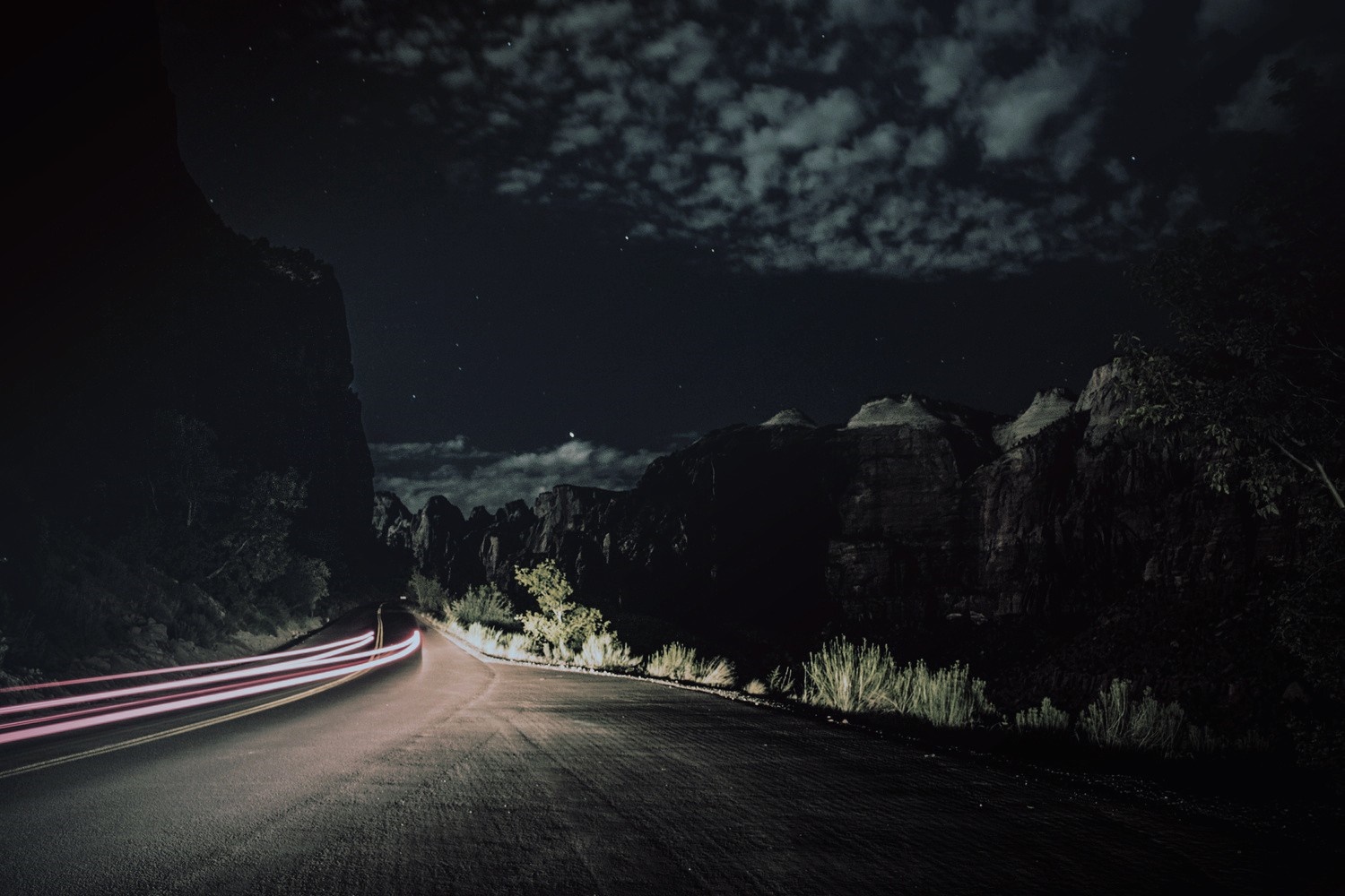 Night road with light trails and mountains under moonlight HD Wallpaper