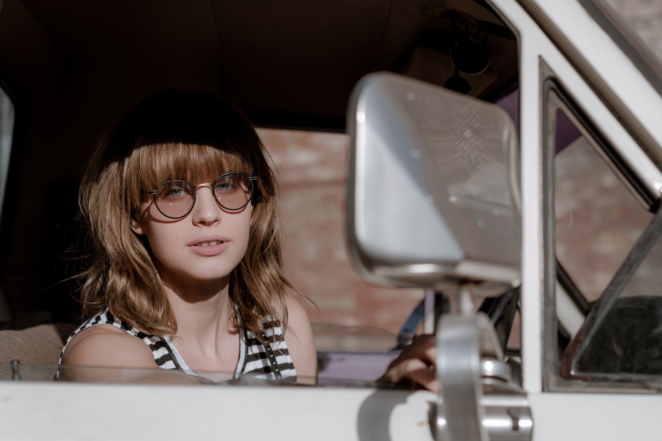 Woman wearing sunglasses in a car HD Wallpaper
