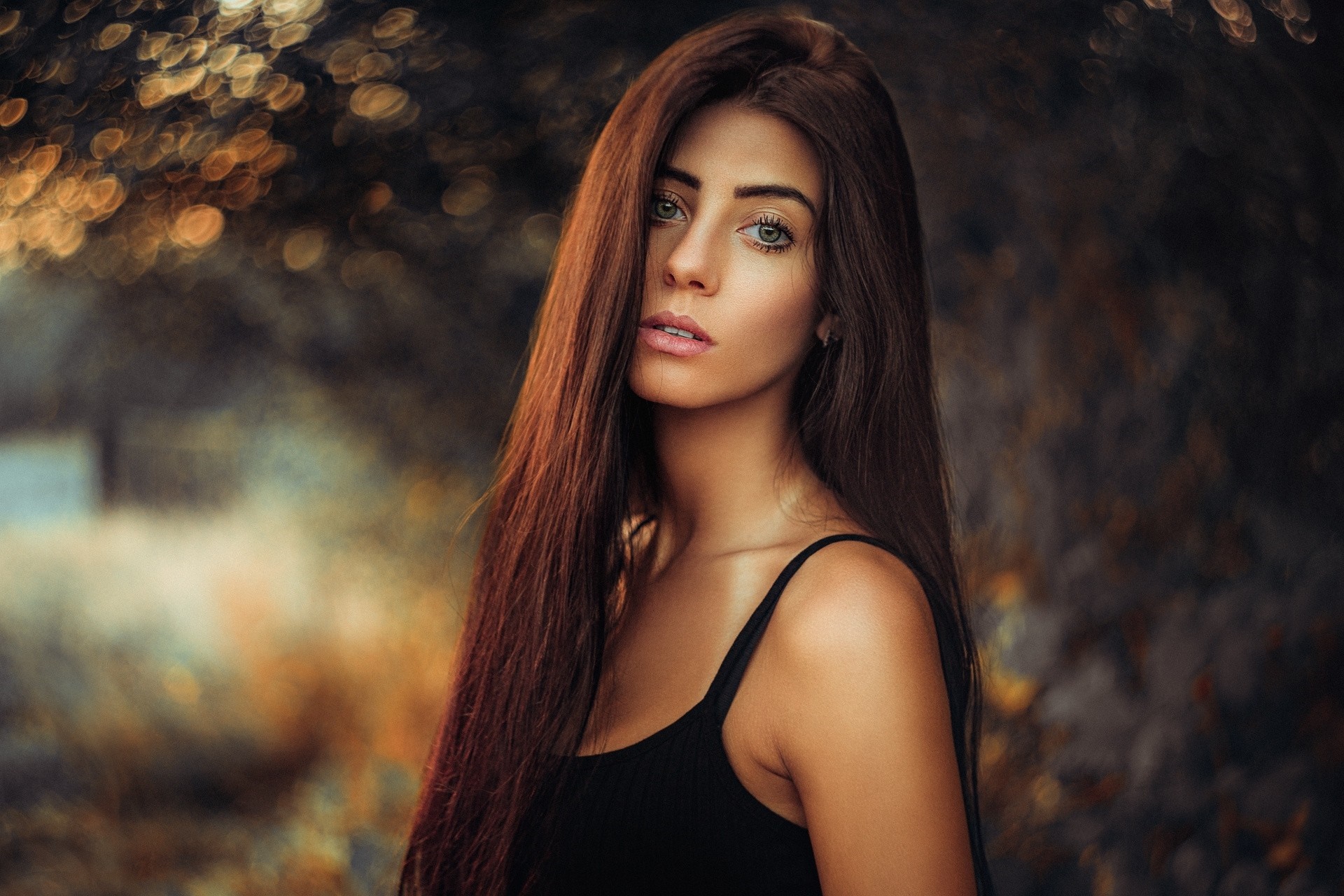 Woman with long brown hair in a black tank top HD Wallpaper