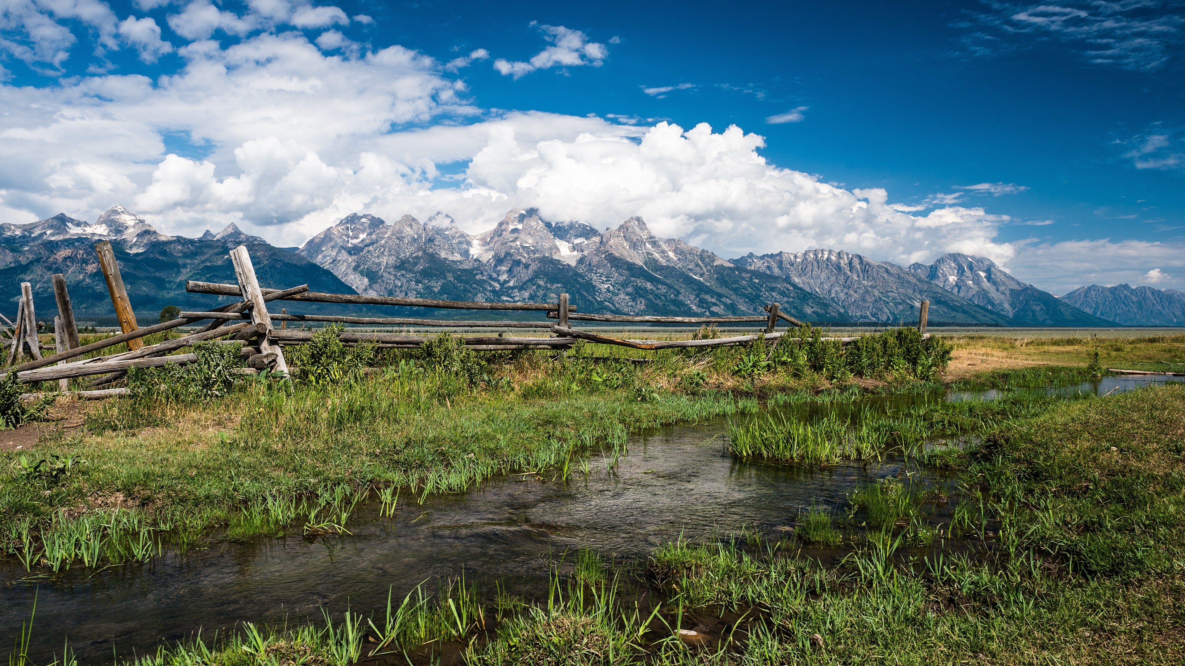 Grand Teton National Park with a wooden fence and stream HD Wallpaper