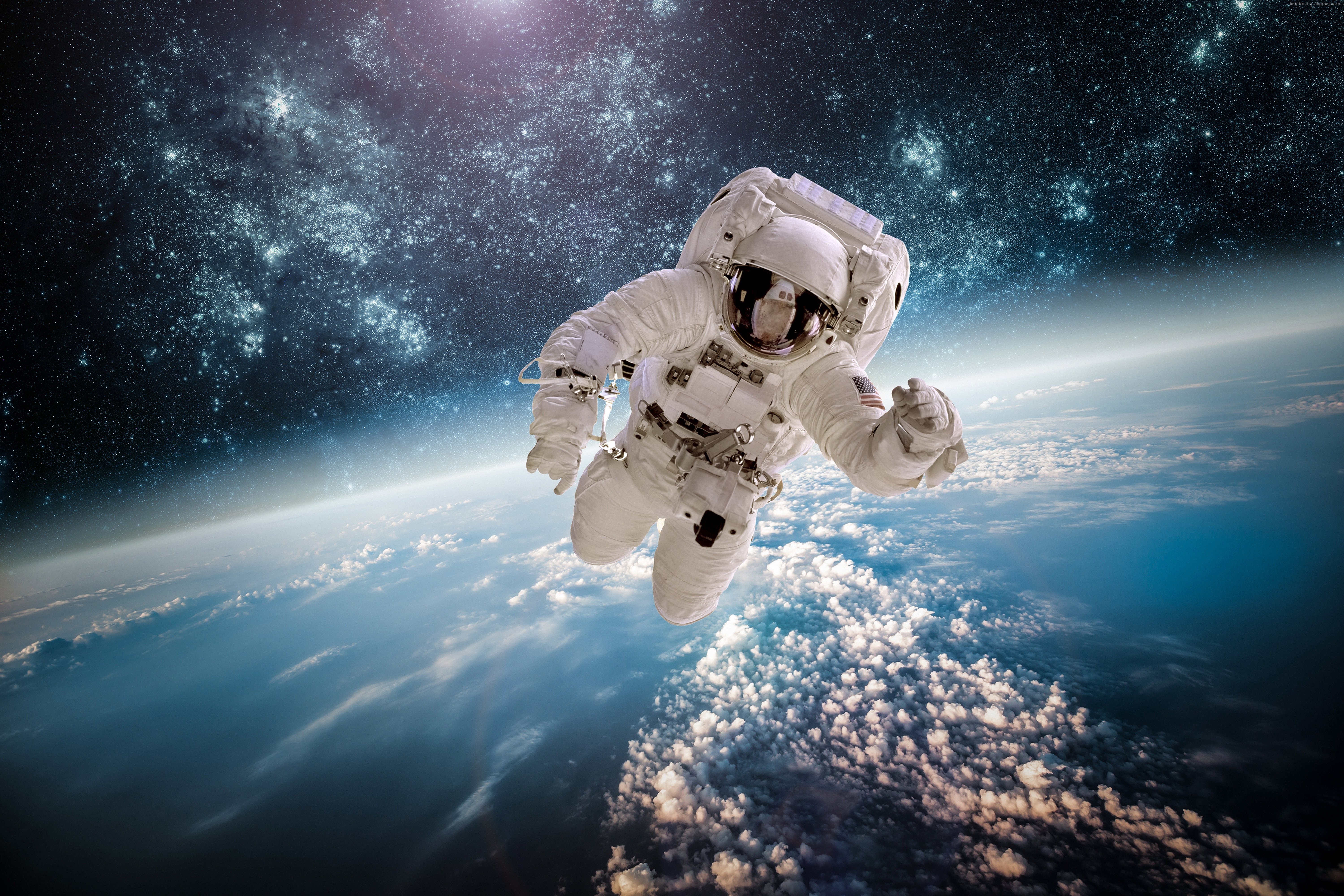 Astronaut floating in space above Earth with stars HD Wallpaper