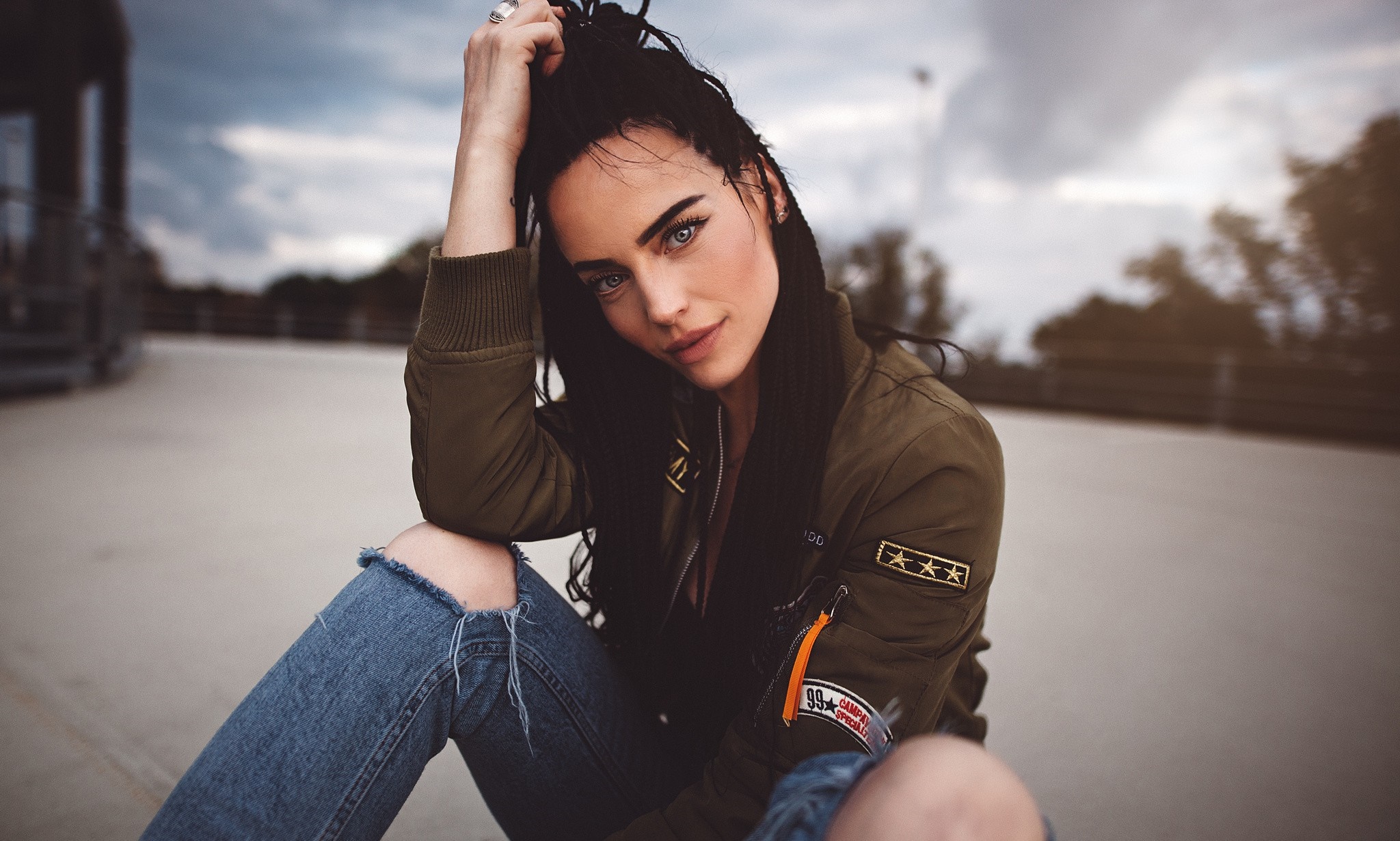 Portrait of Woman in Torn Jeans and Green Jacket HD Wallpaper