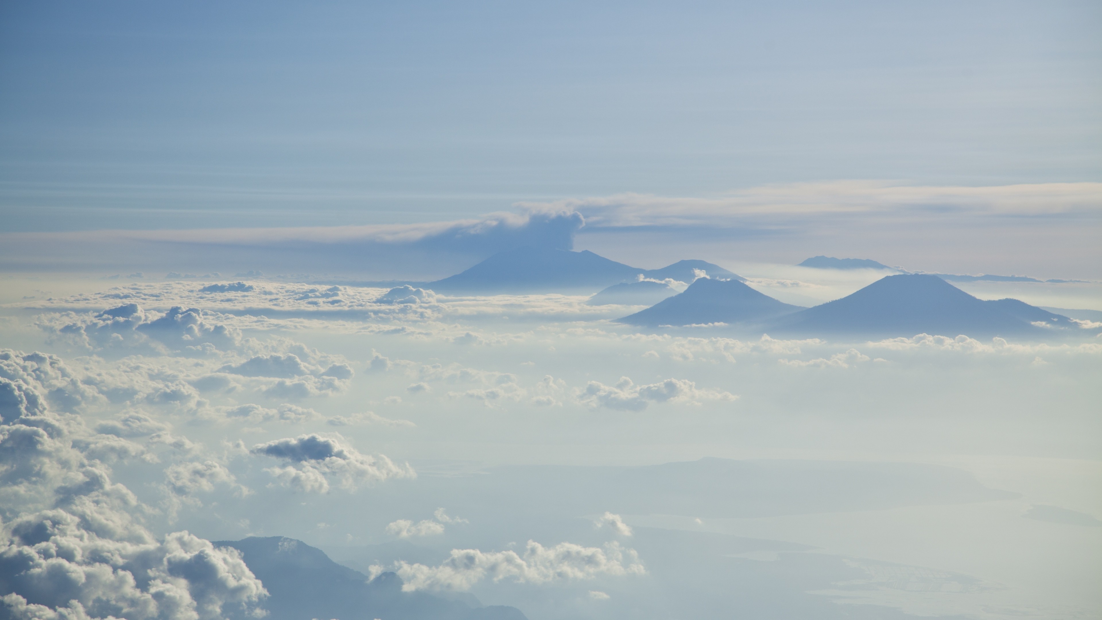 Mountains above clouds in the sky HD Wallpaper