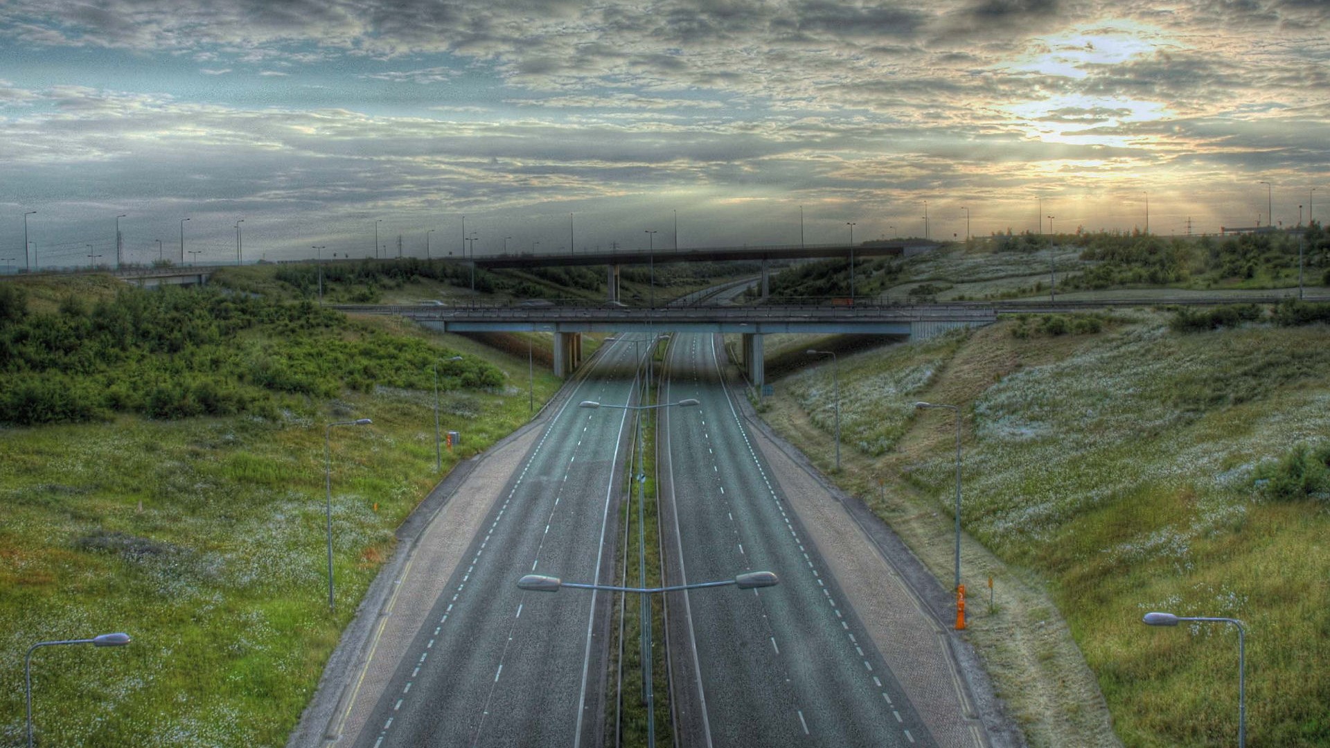 Highway interchange with overpasses and streetlights HD Wallpaper