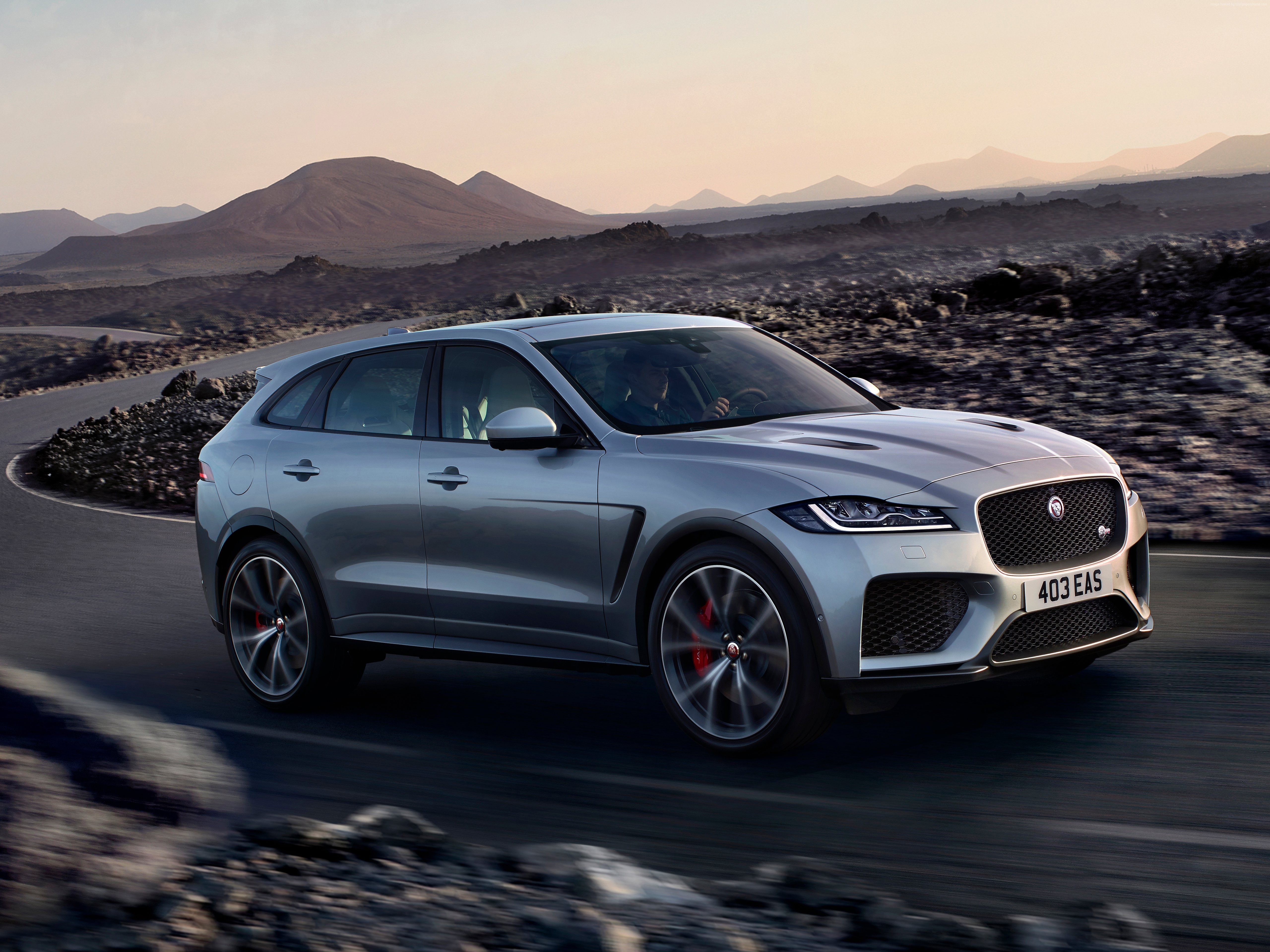 Silver 2019 Jaguar F-Pace driving on a mountain road HD Wallpaper