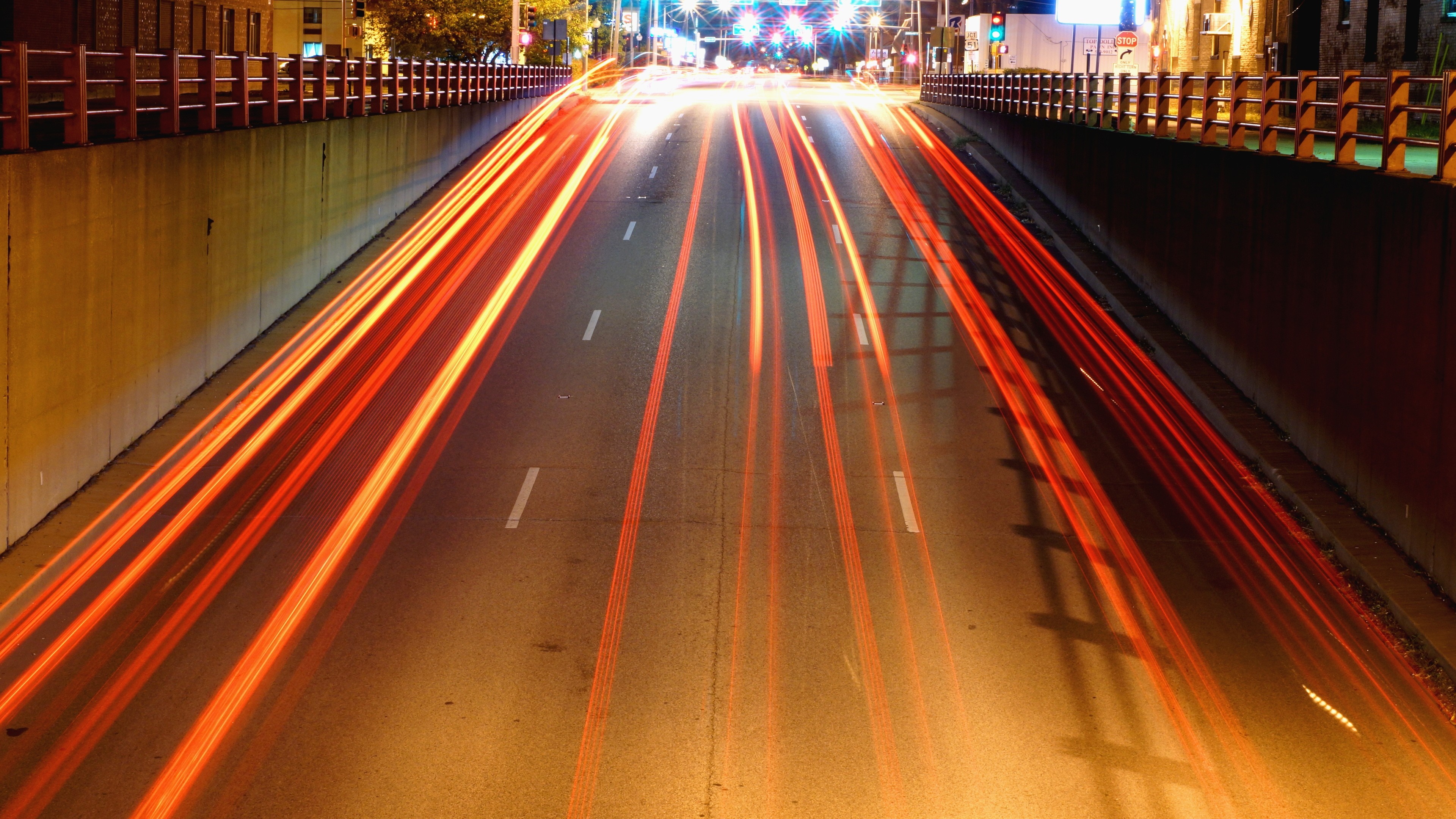 Long exposure of traffic light trails on a highway at night HD Wallpaper