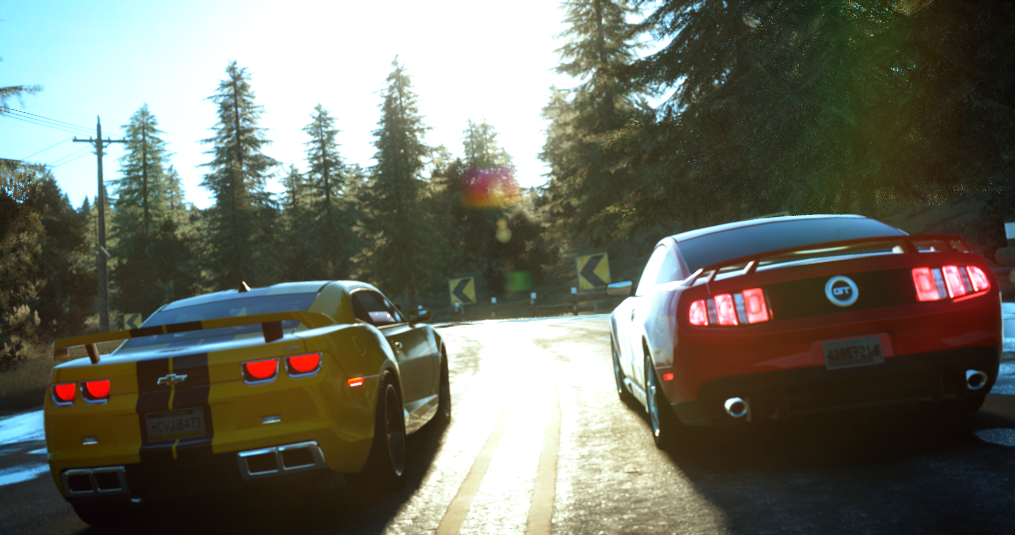 Chevrolet Camaro and Ford Mustang racing on a mountain road HD Wallpaper
