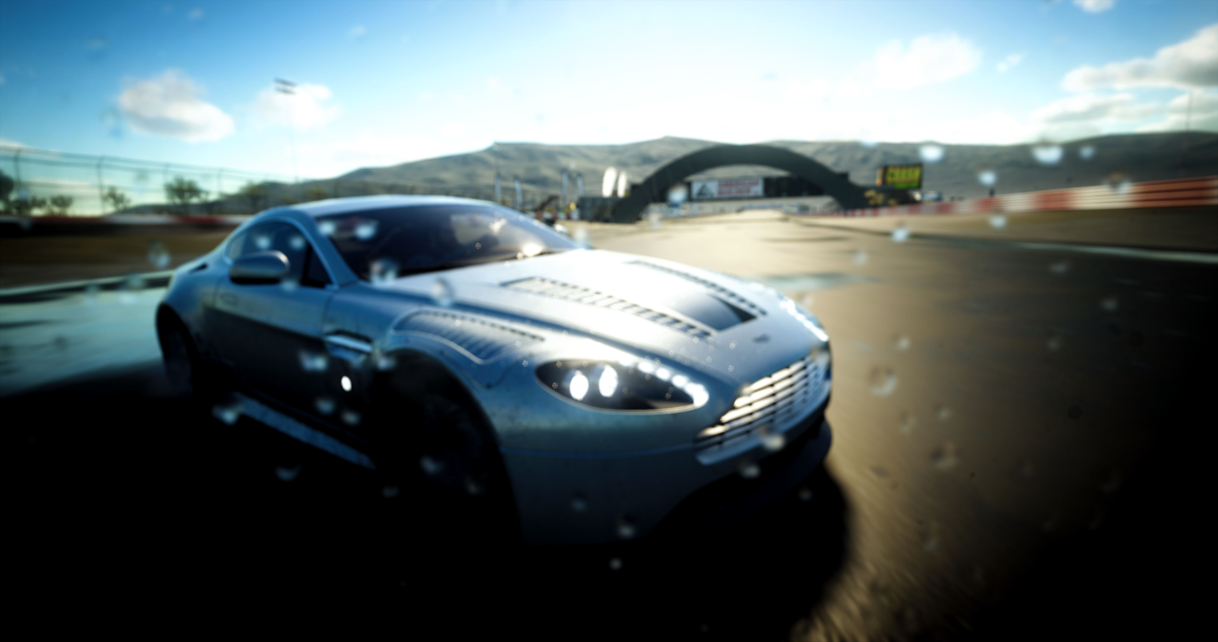 Aston Martin sports car on a wet race track HD Wallpaper