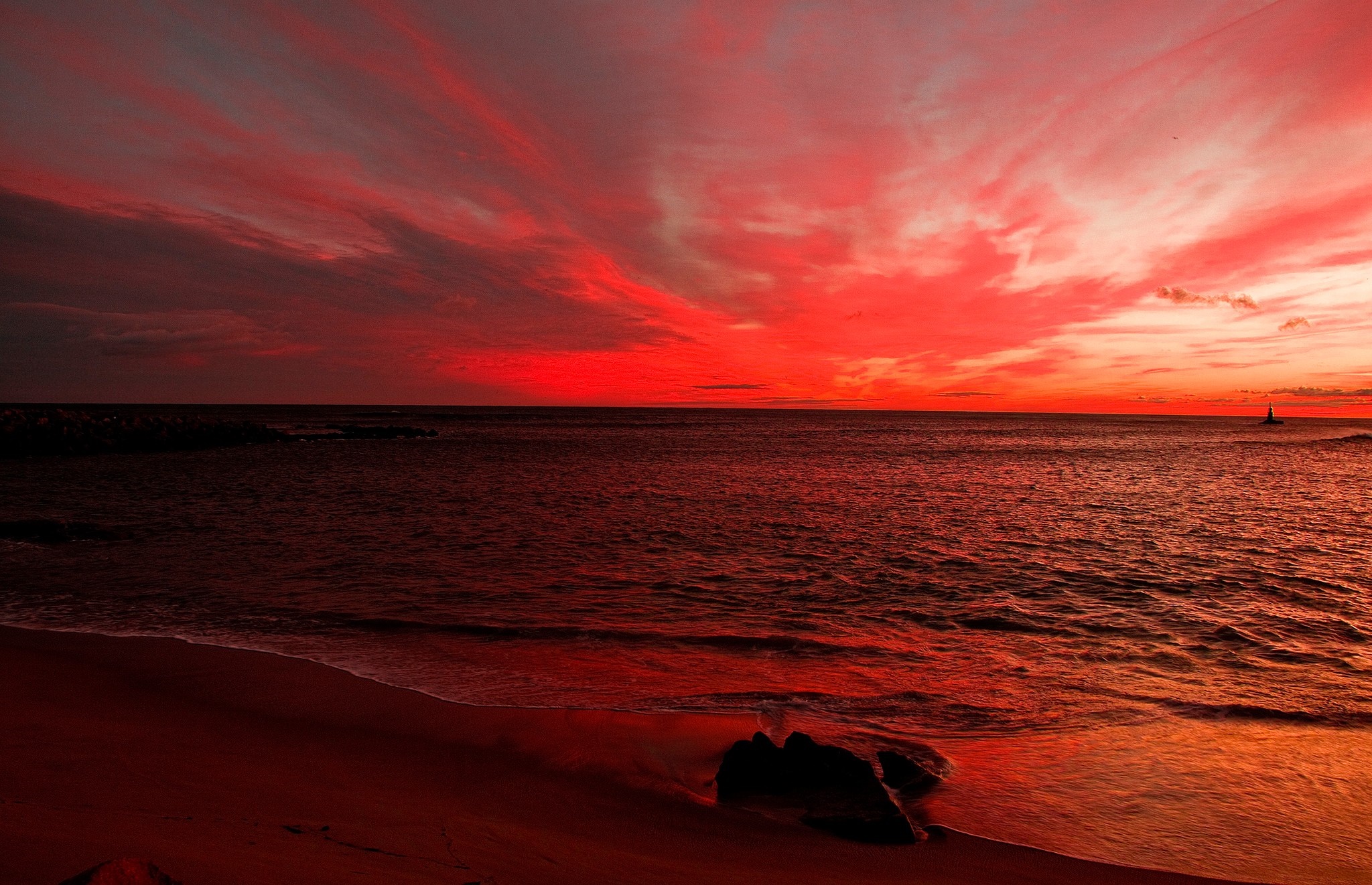 Dramatic red sunset over the ocean with a sailboat HD Wallpaper