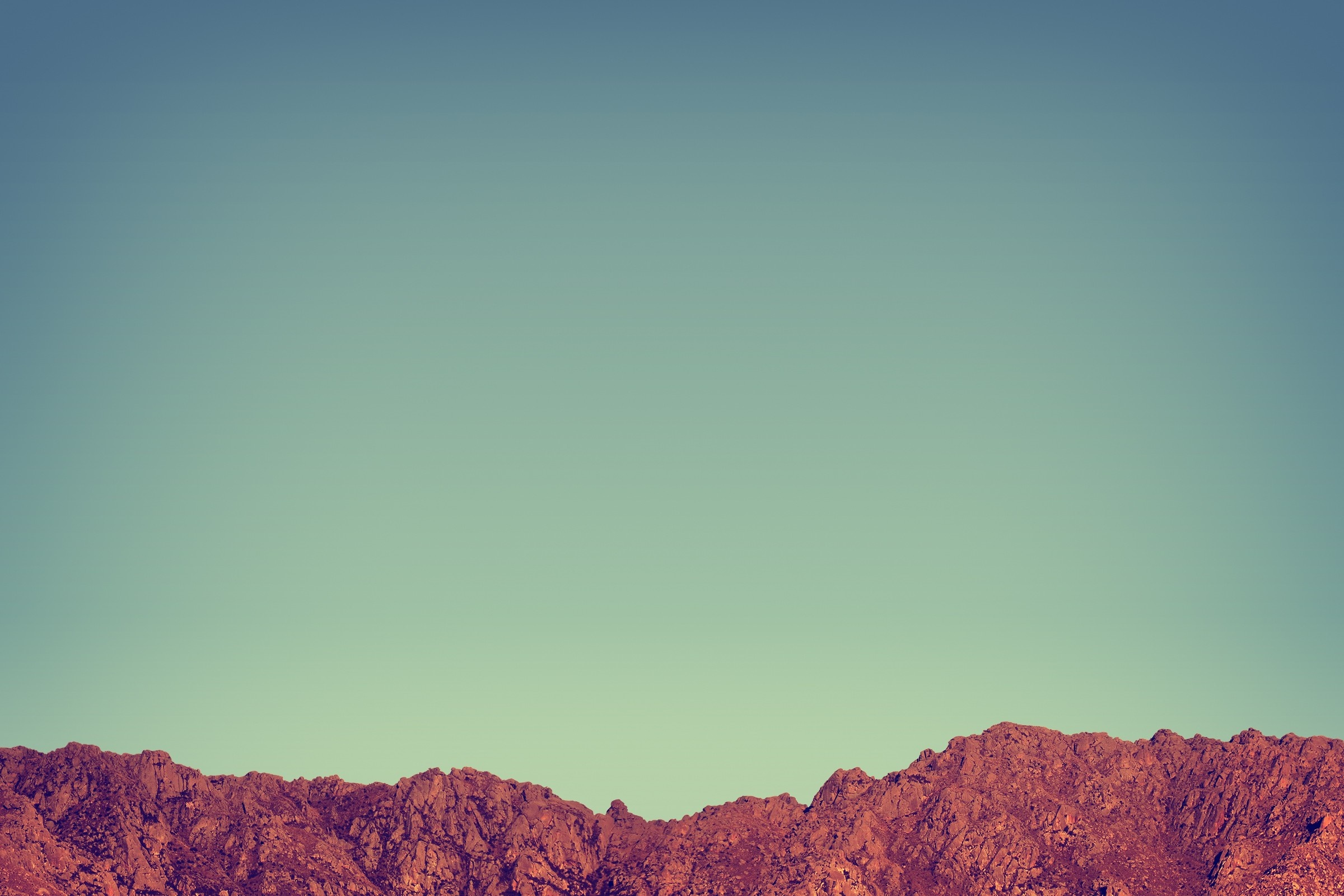 Mountain range against a clear sky HD Wallpaper