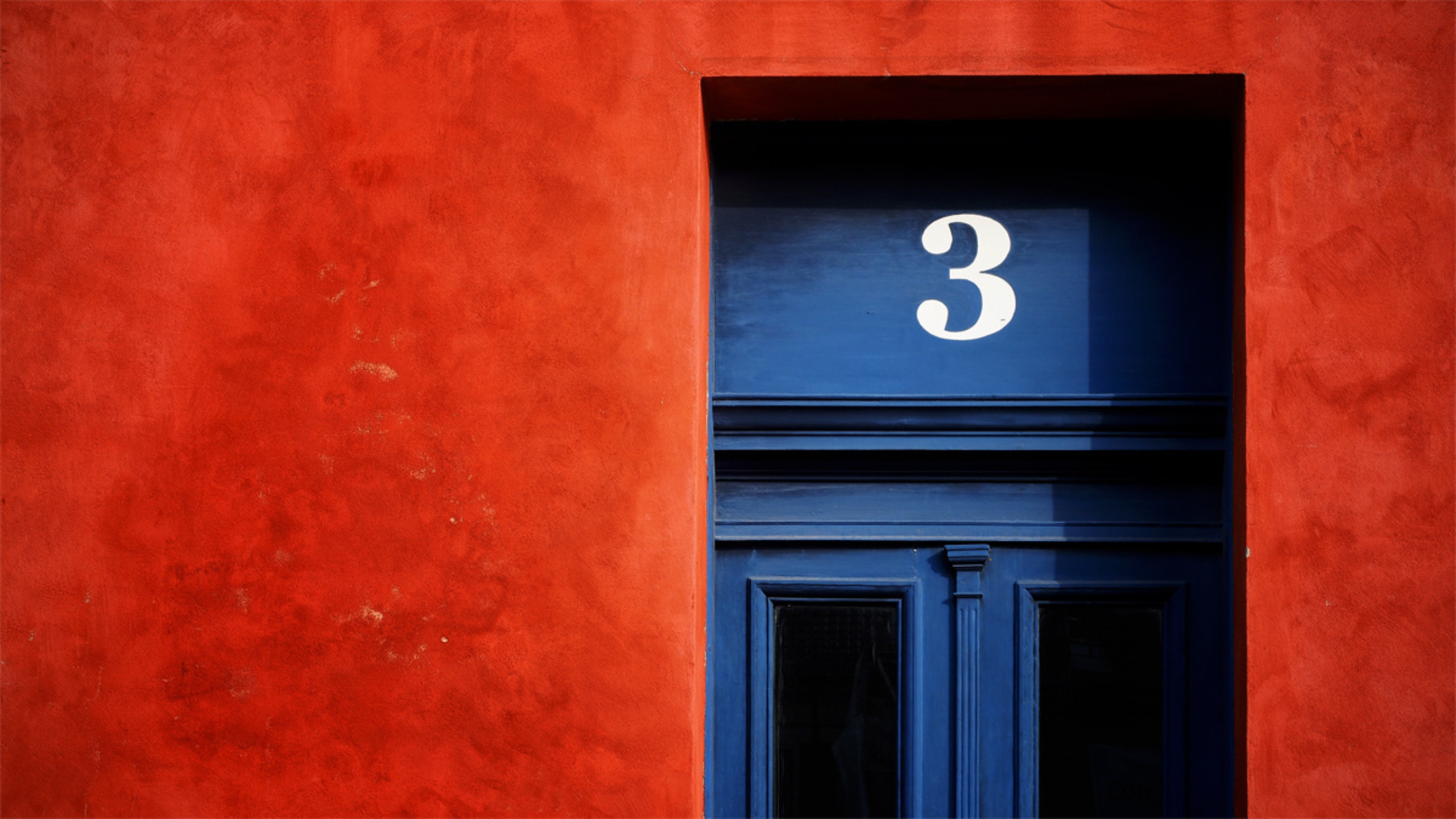 Blue door with number 3 on red wall HD Wallpaper