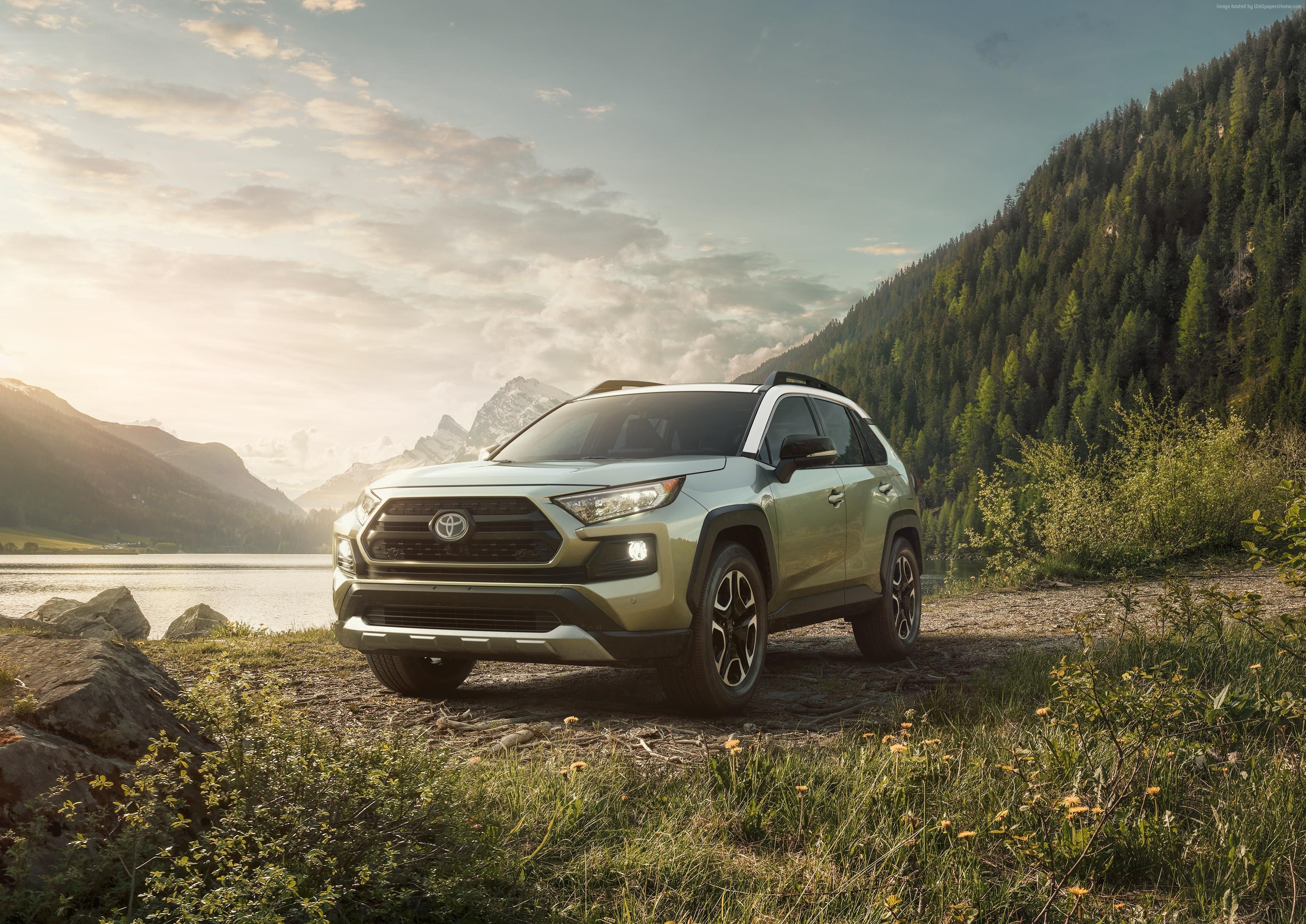 2019 Toyota RAV4 SUV parked by a lake and mountains HD Wallpaper