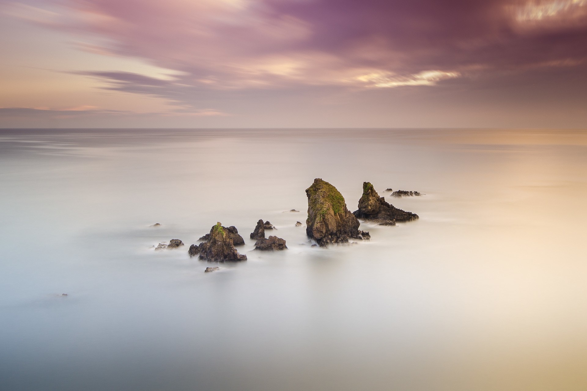Rocks in the sea at sunset HD Wallpaper