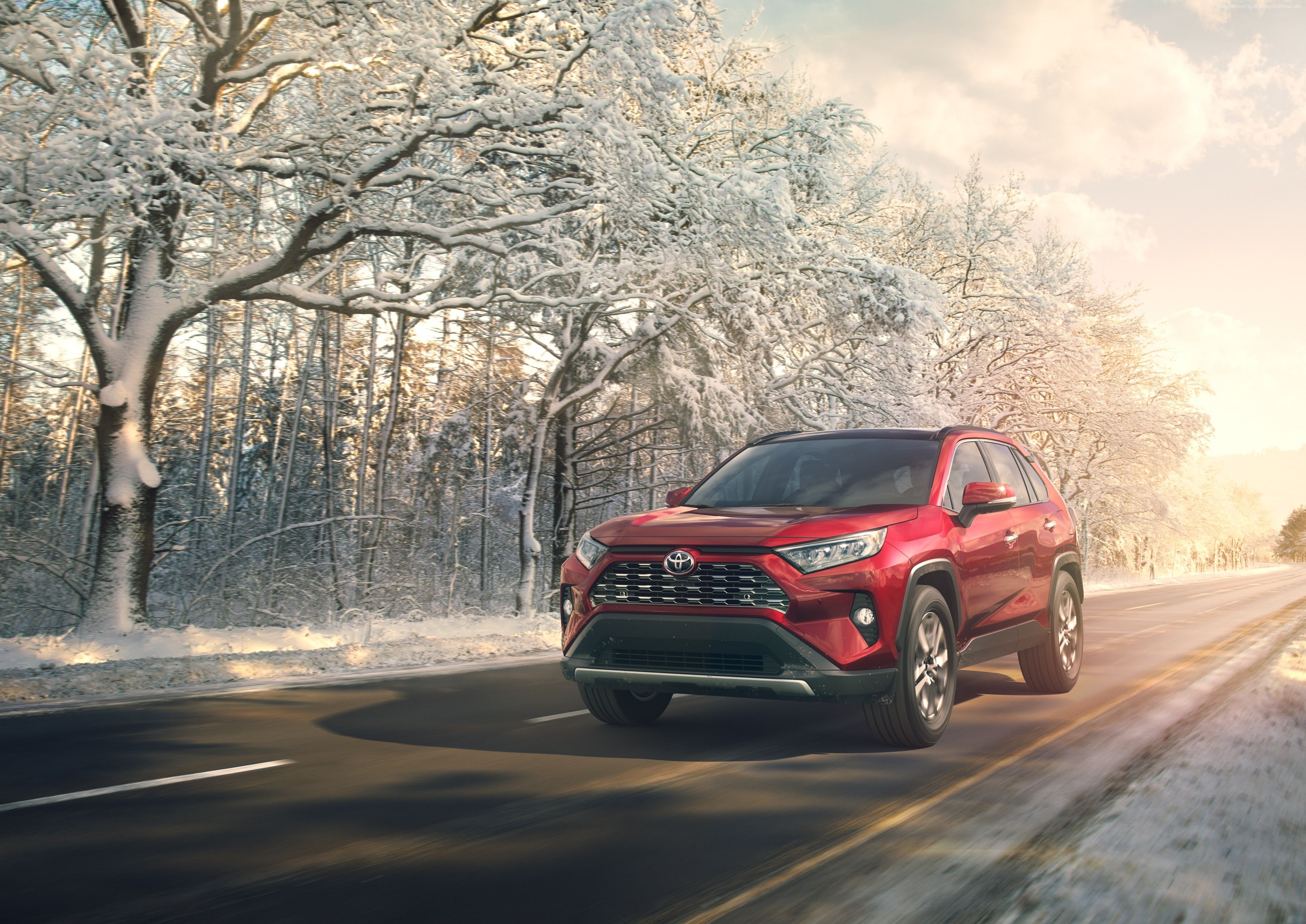 Red Toyota RAV4 driving on a snowy road HD Wallpaper