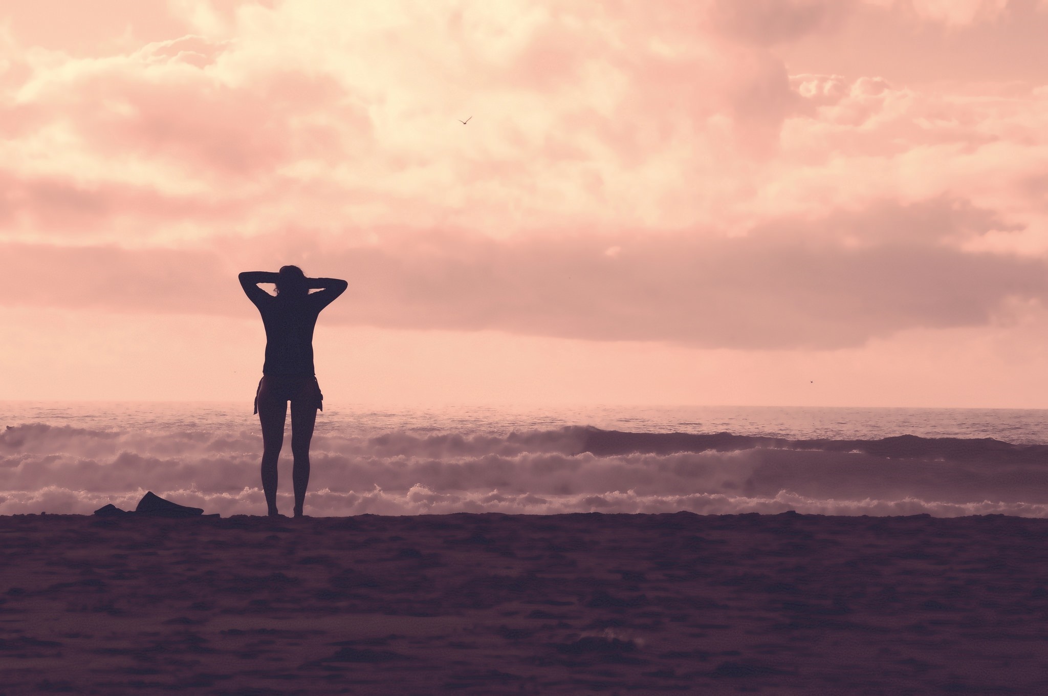 Silhouette of a woman on a beach at sunset HD Wallpaper