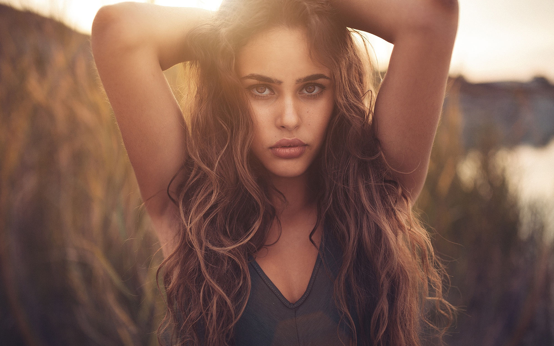 Woman with hands in her long brown hair HD Wallpaper