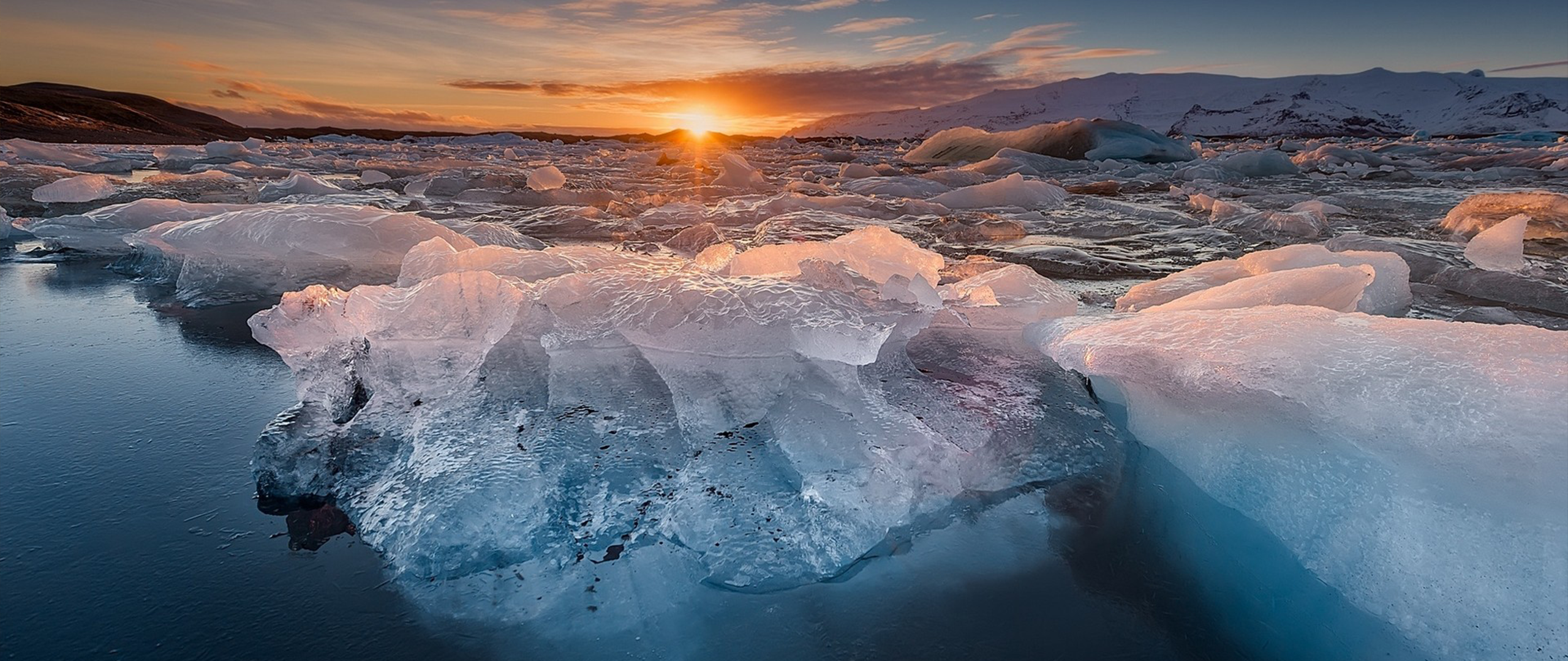 Icebergs floating in the ocean at sunrise HD Wallpaper