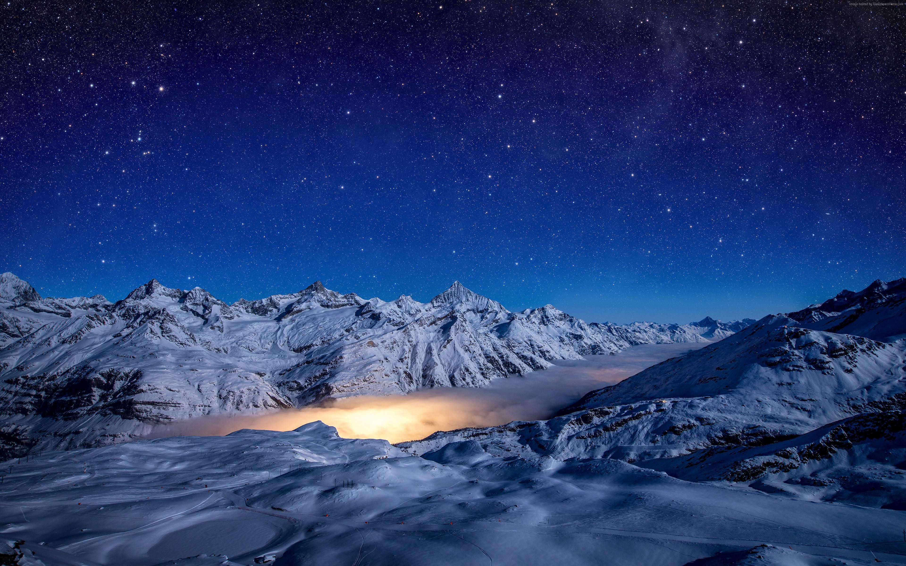 Snowy Mountains Under a Starry Night Sky 4K HD Wallpaper