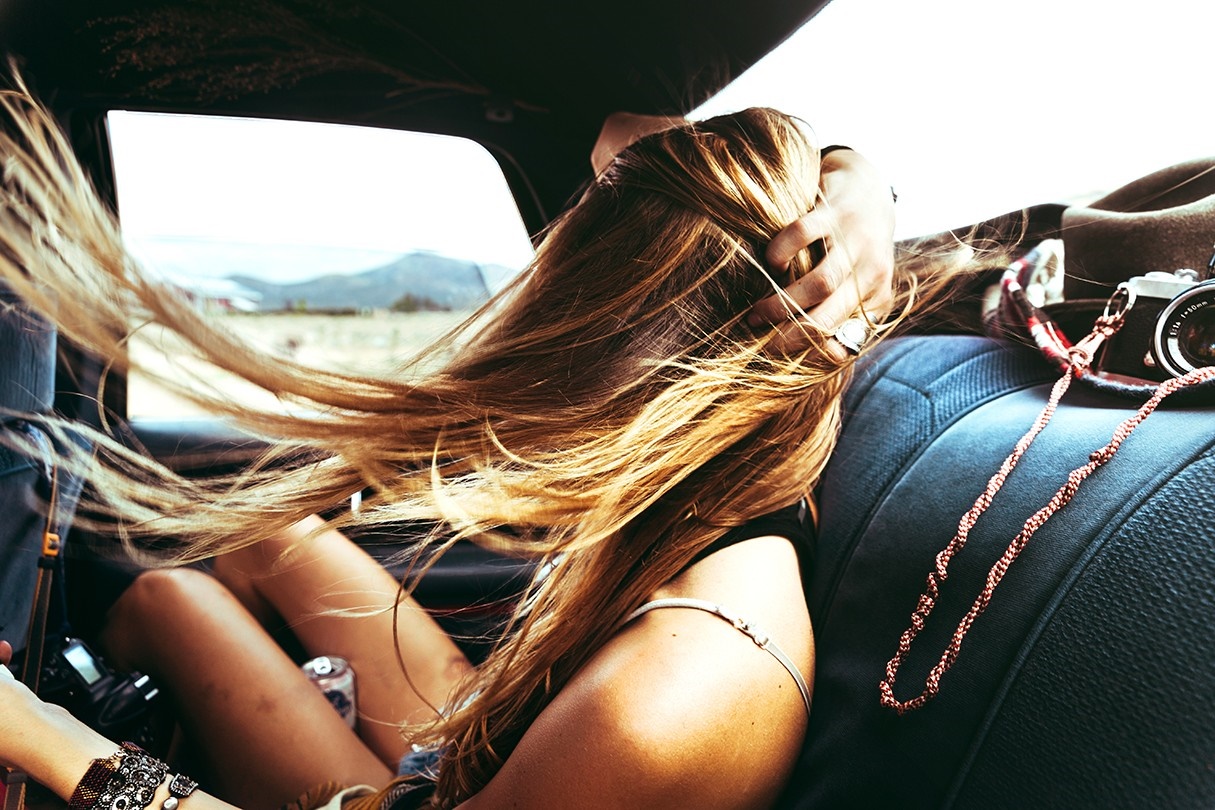 Woman with long hair in a car with a camera HD Wallpaper