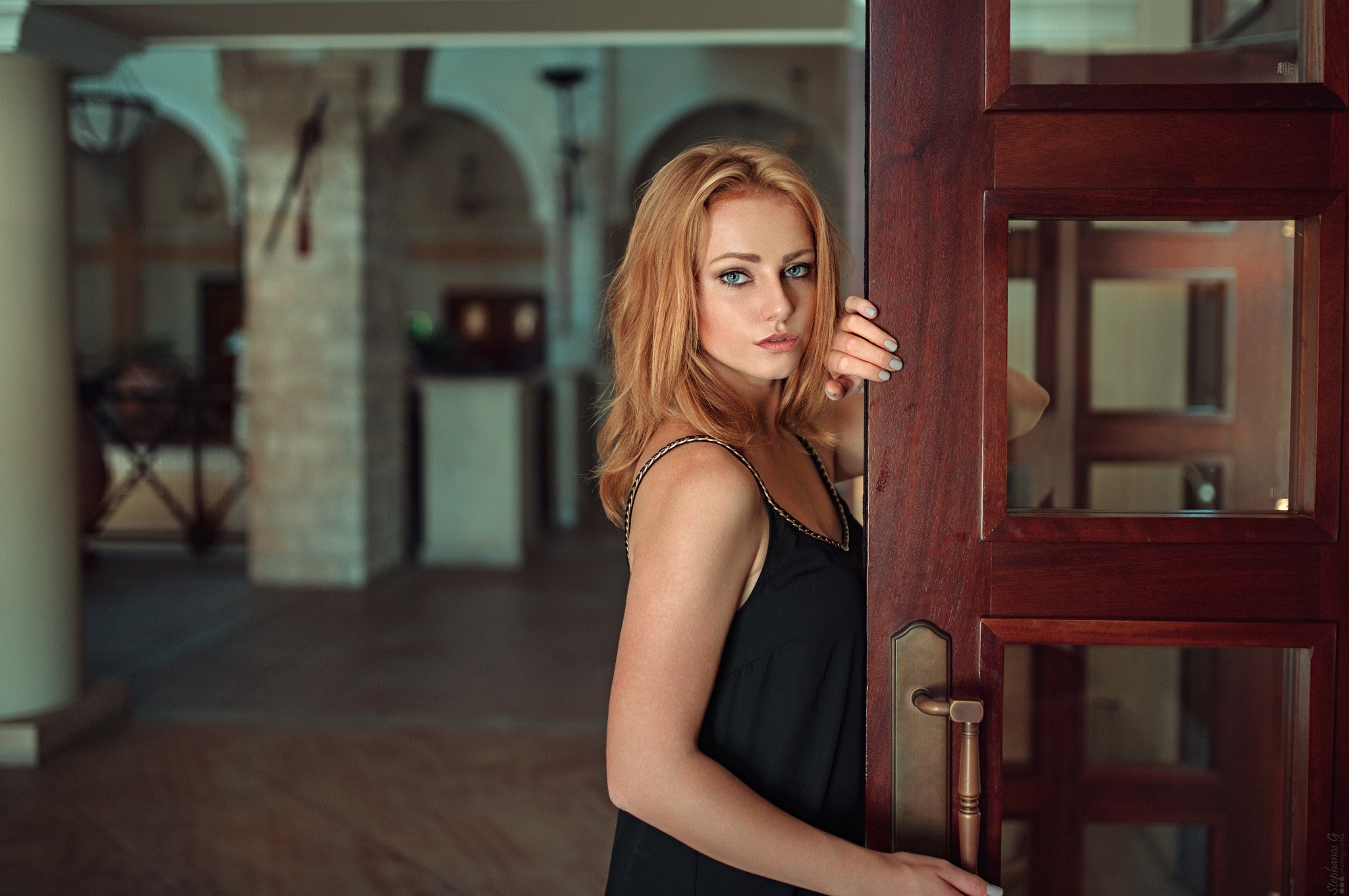 Woman with red hair peeking through a wooden door HD Wallpaper