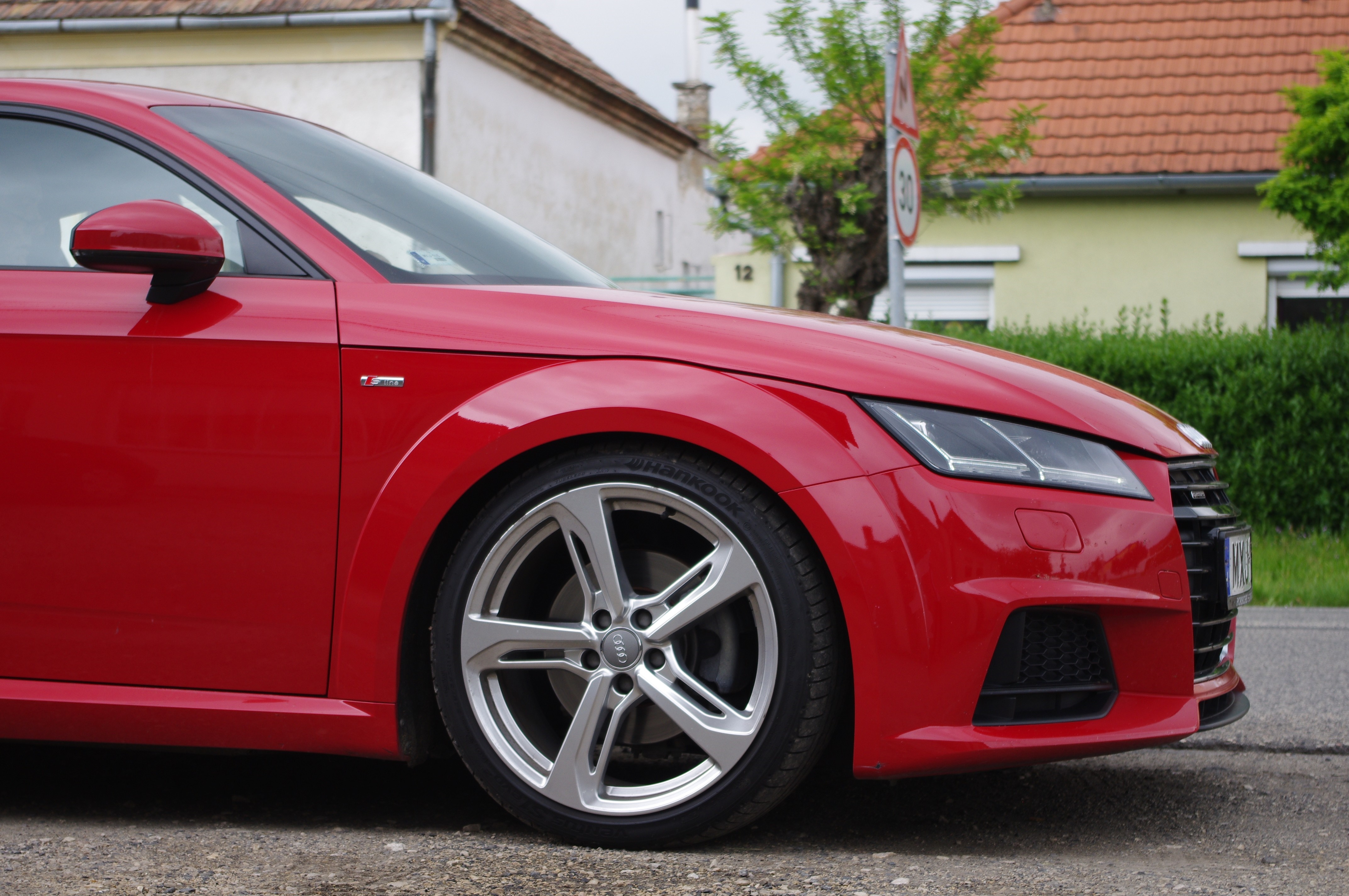 Red Audi TT sports car front wheel and bumper HD Wallpaper