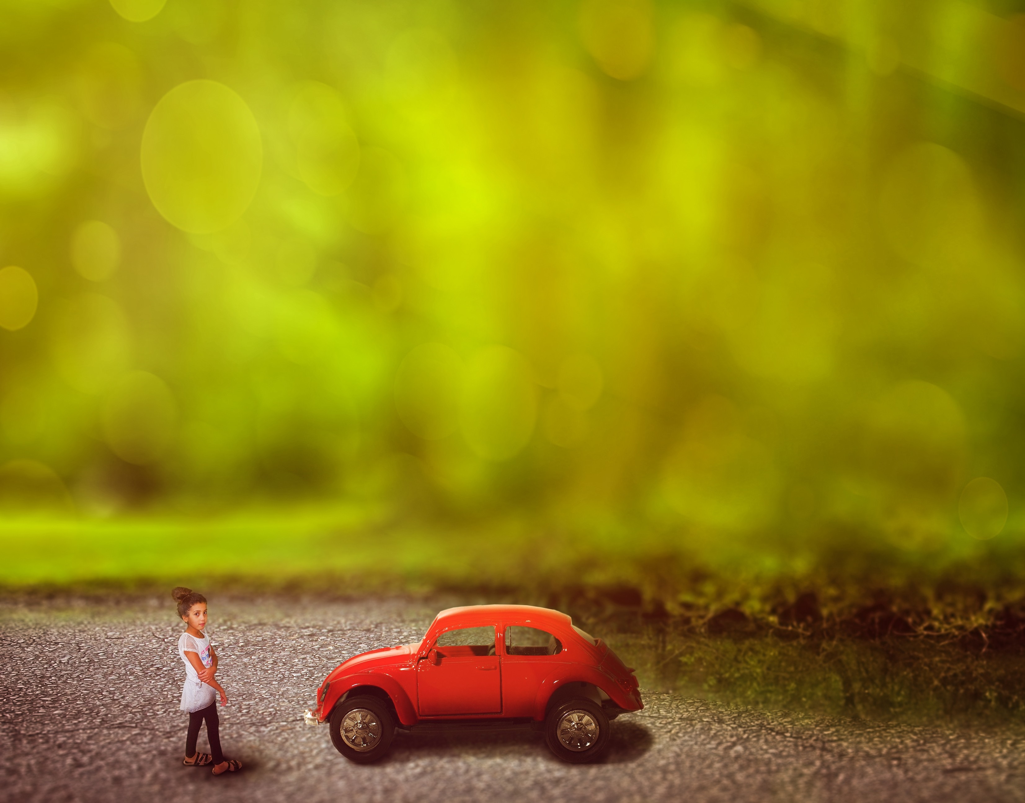 Girl and red toy car in sunlight HD Wallpaper