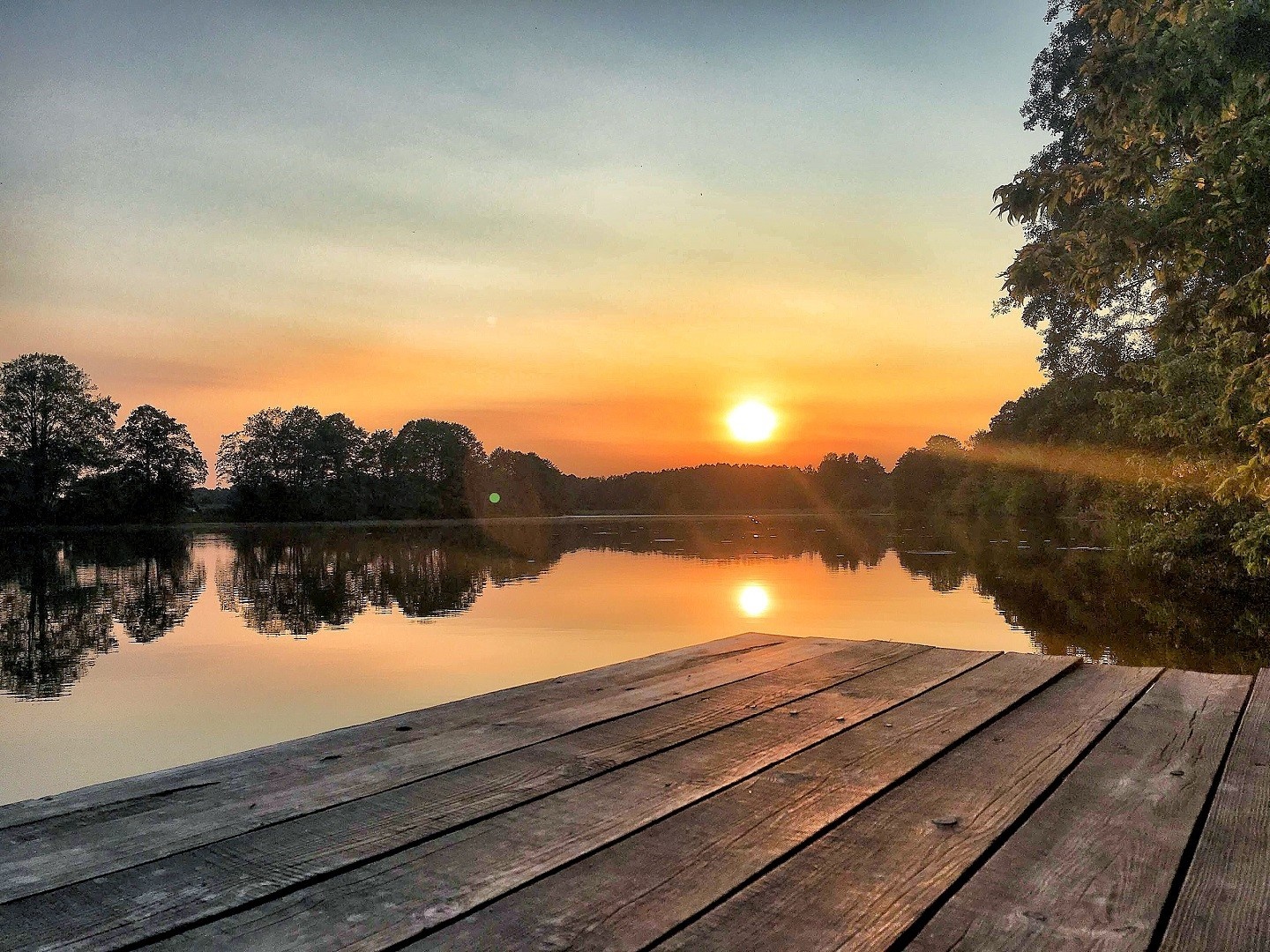 Wooden dock on a lake at sunset HD Wallpaper