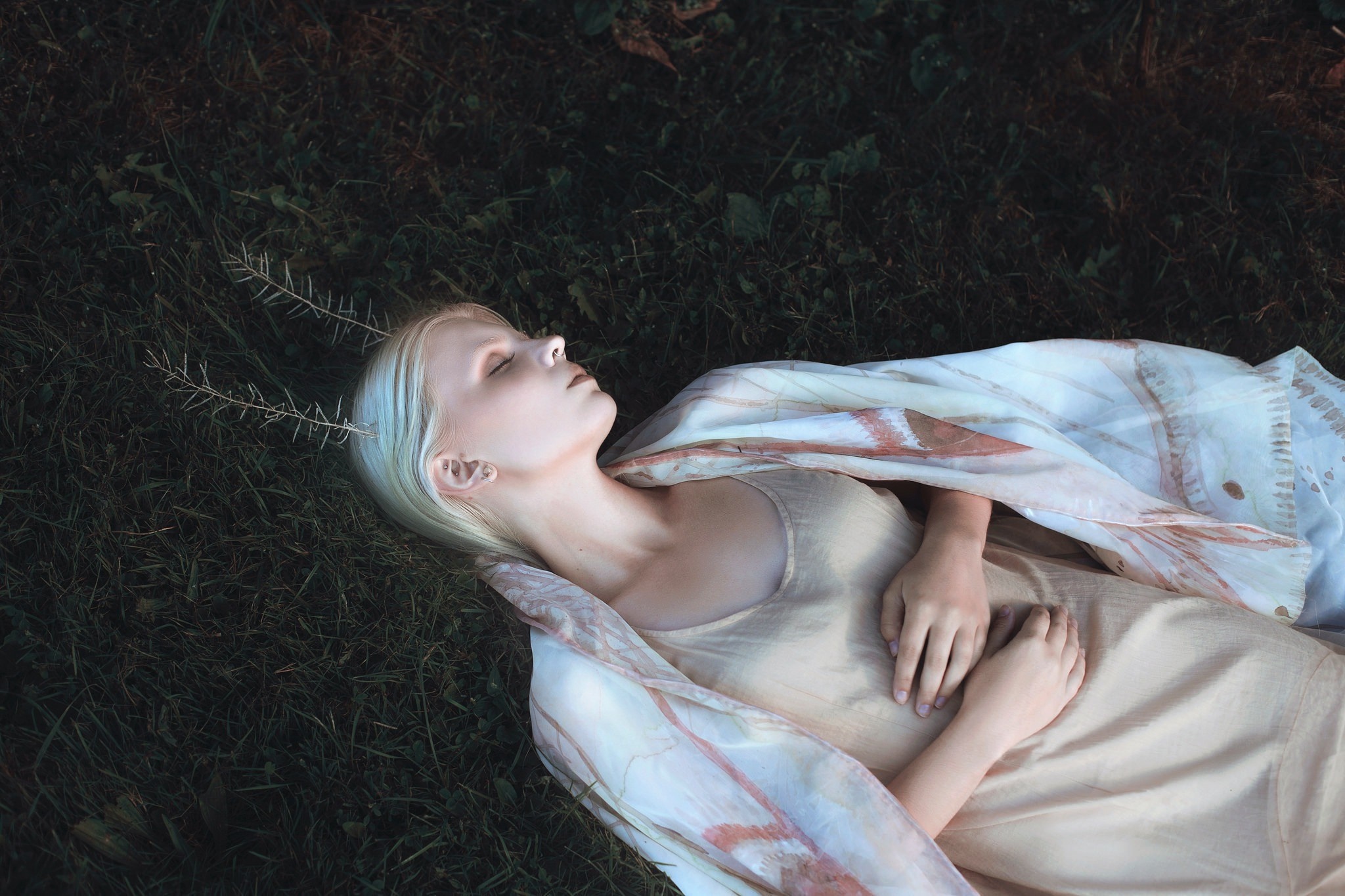 Woman lying in grass with branches in hair HD Wallpaper