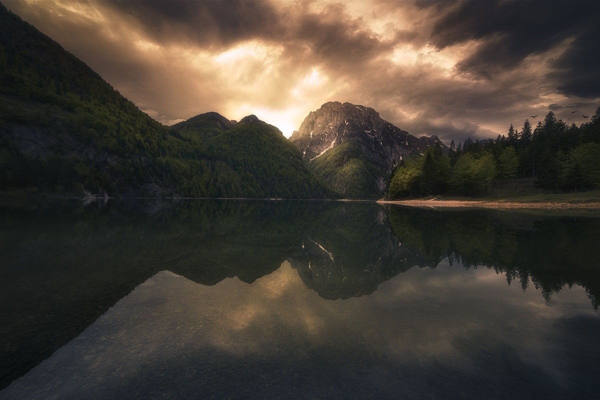 Lake reflection of mountains and dramatic sky HD Wallpaper