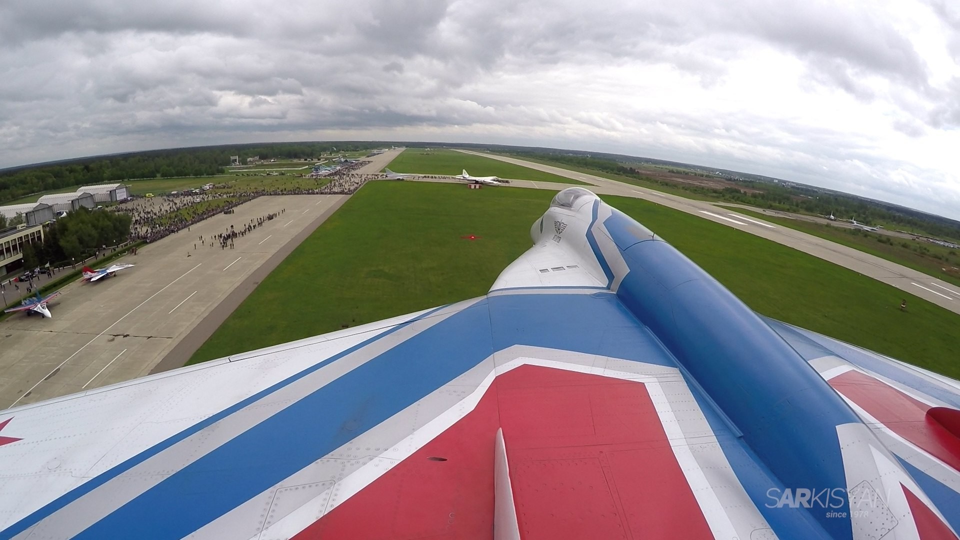 Aerobatic team flying over a runway with spectators HD Wallpaper