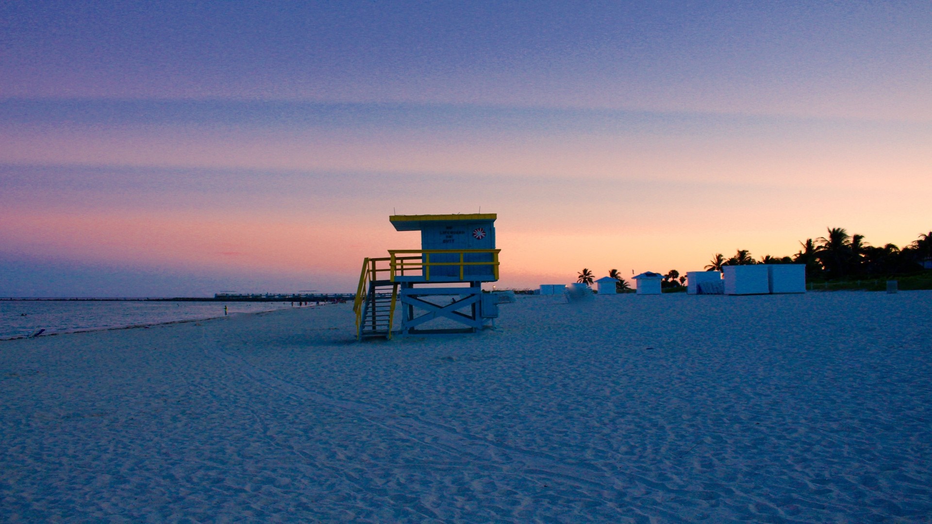 Lifeguard tower on a beach at sunset HD Wallpaper