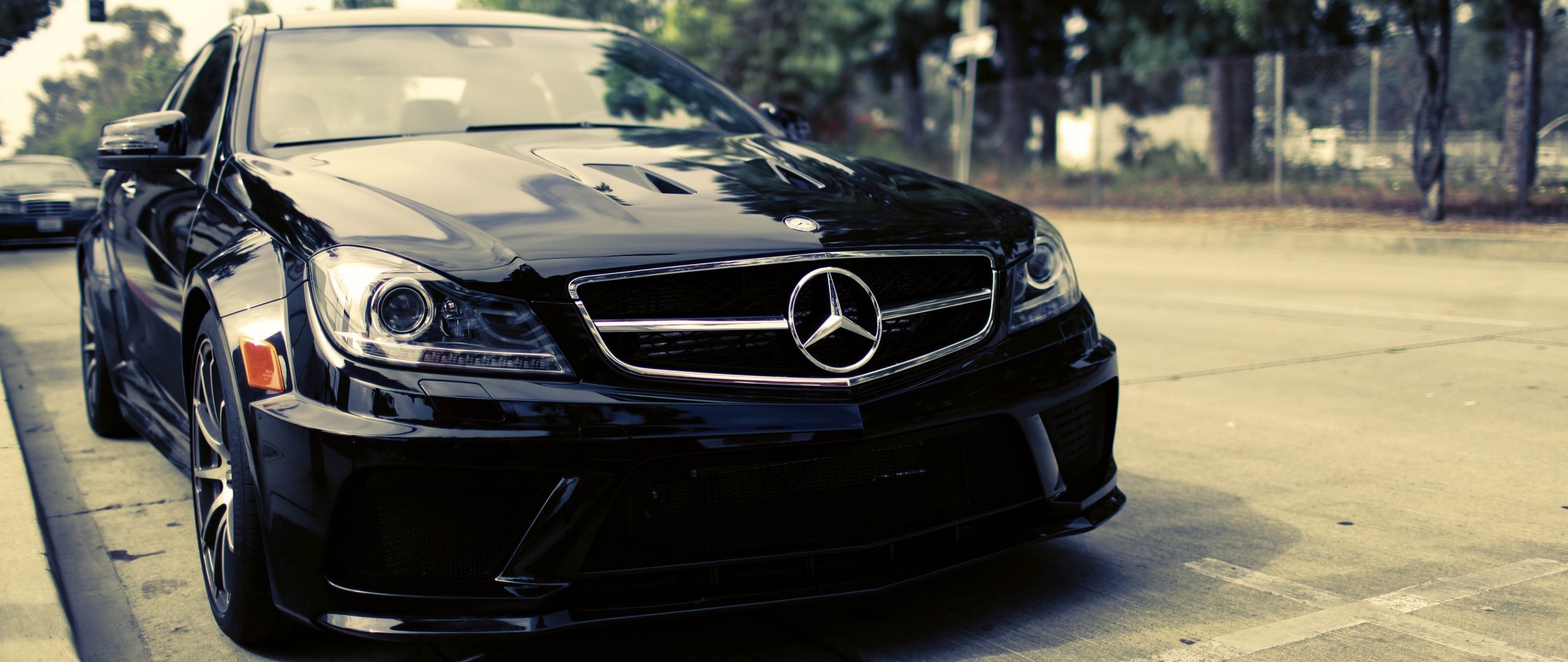 Black Mercedes-Benz C-Class parked on the side of the road HD Wallpaper