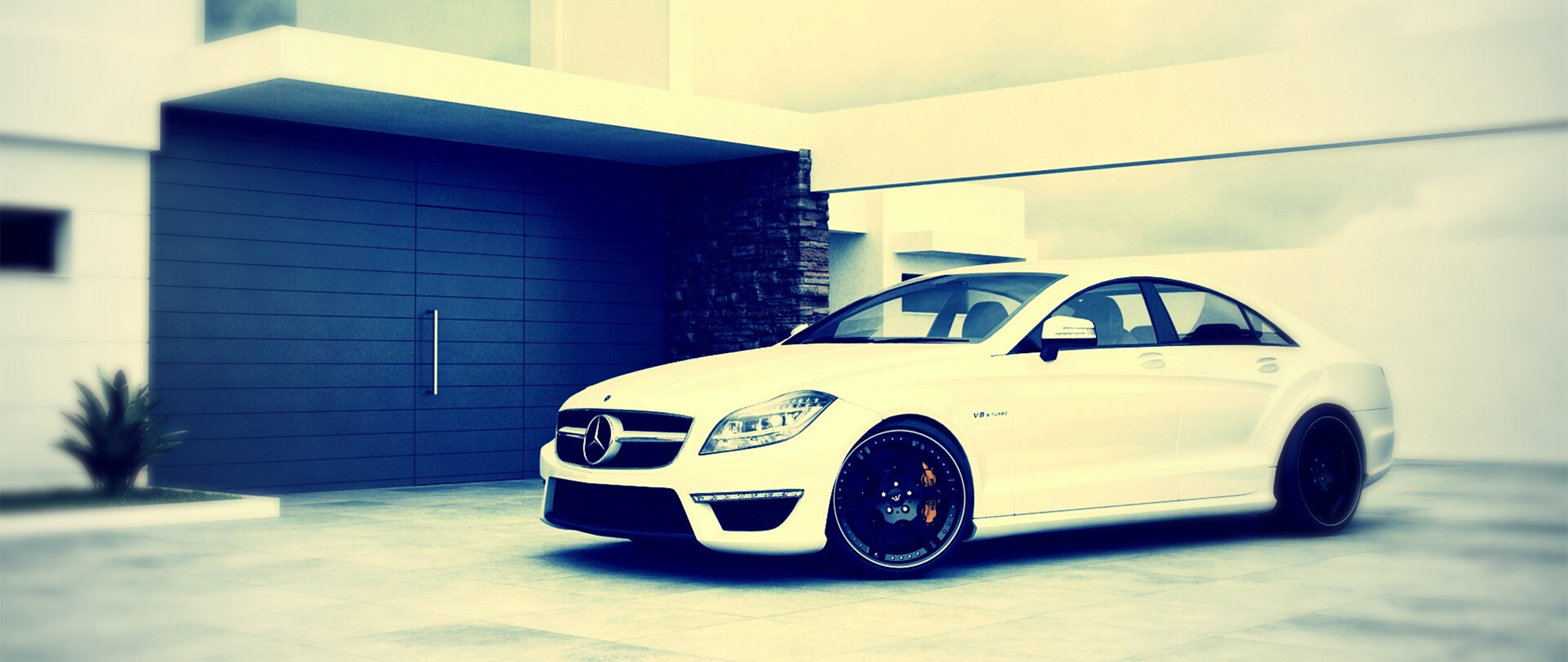 White Mercedes-Benz CLS 63 AMG parked in front of modern house HD Wallpaper