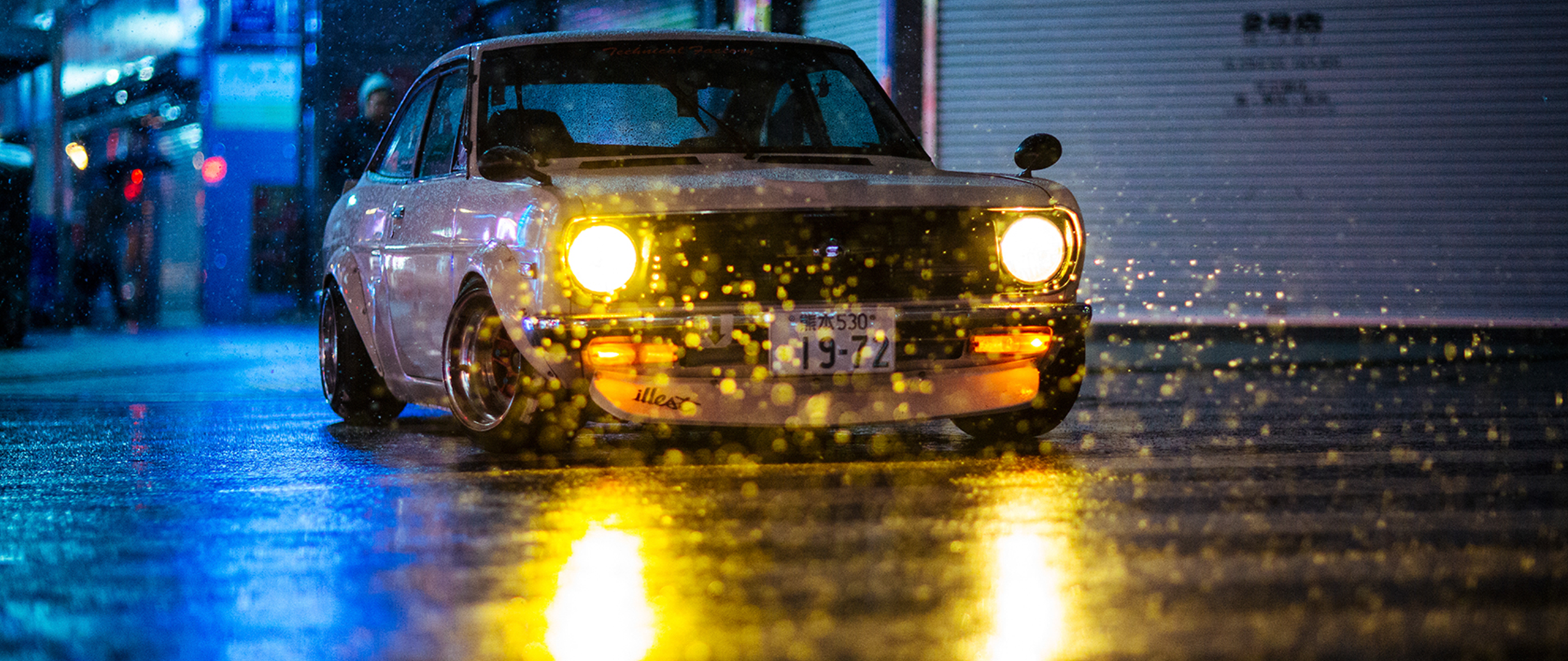Classic car driving on a wet street at night HD Wallpaper