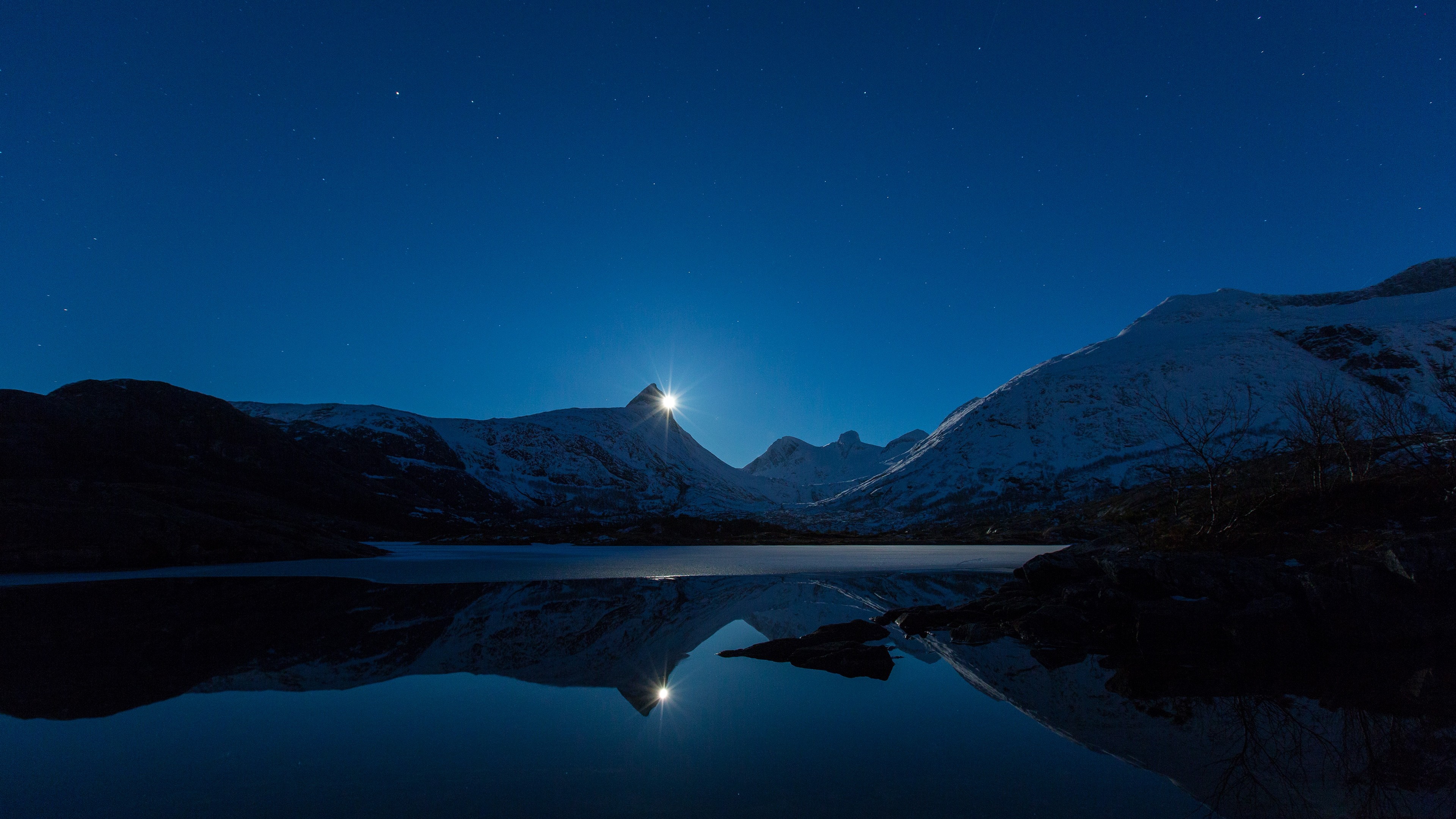 Moonlight over snow-capped mountains and a reflective lake HD Wallpaper