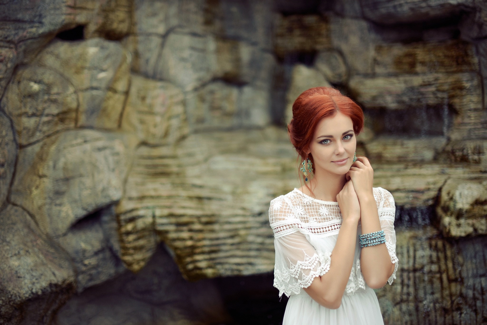 Redhead woman in white dress posing in front of rock formation HD Wallpaper