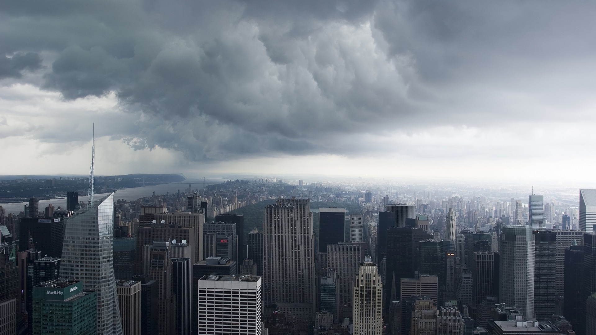 New York City skyline under stormy clouds HD Wallpaper