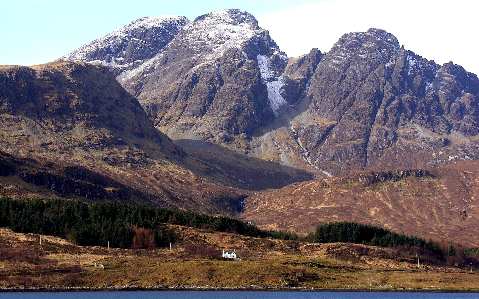 Snow-capped mountains and a small white house HD Wallpaper