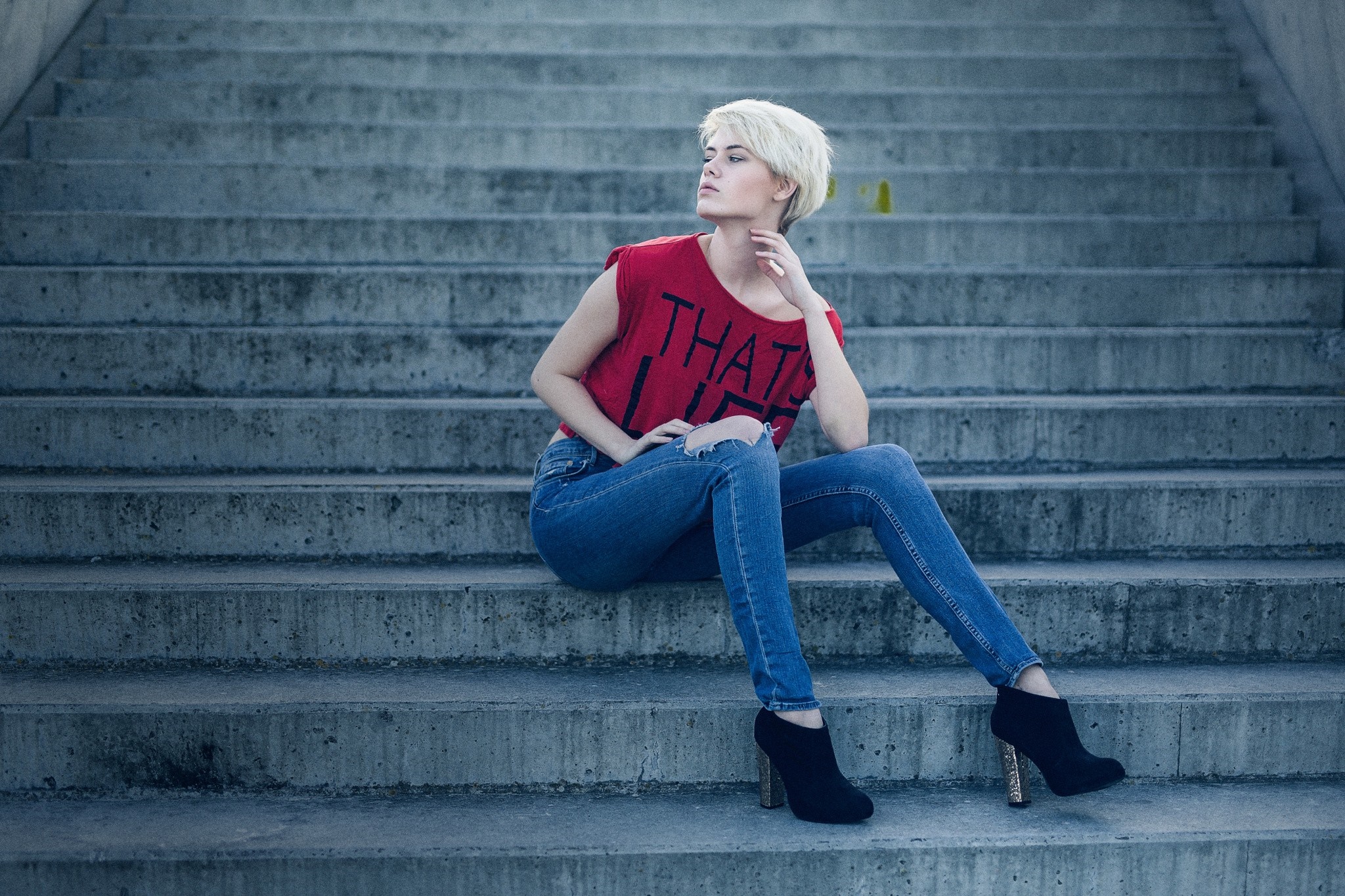 Woman in red top and jeans sitting on stairs HD Wallpaper