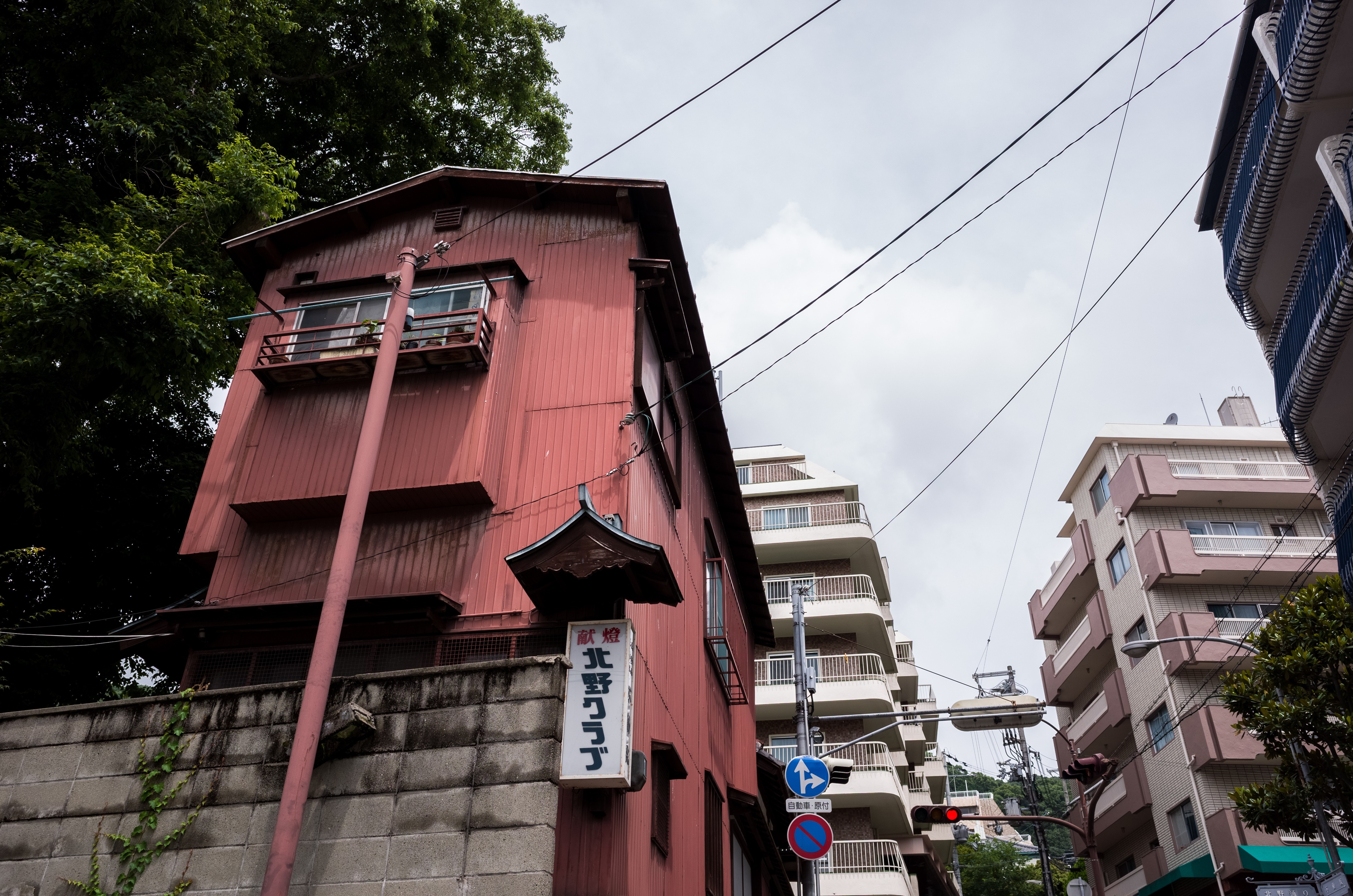 Red building with Japanese signs and apartment buildings HD Wallpaper