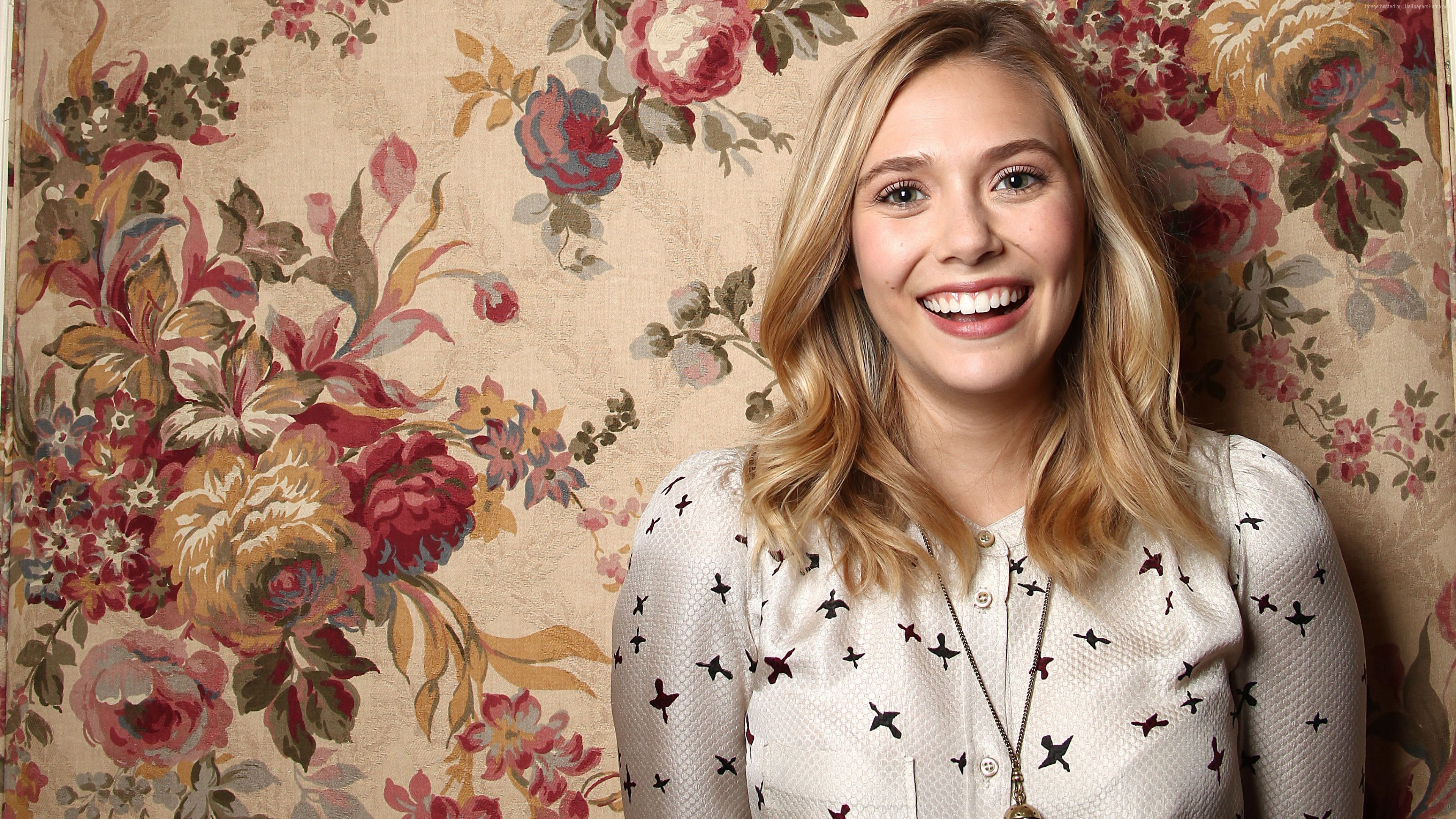 Elizabeth Olsen posing in front of floral wallpaper HD Wallpaper