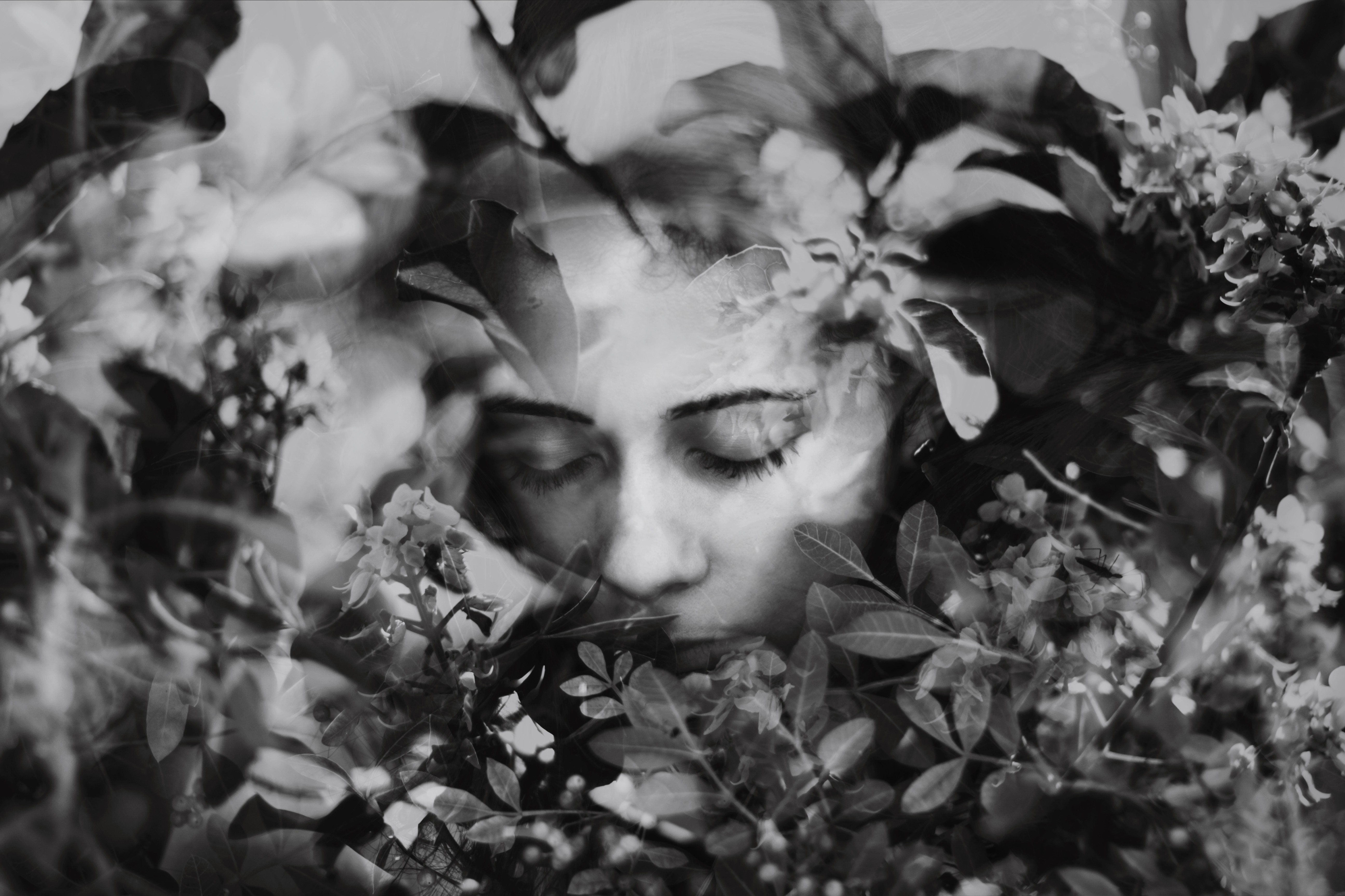 Monochrome double exposure of a woman's face and flowers HD Wallpaper