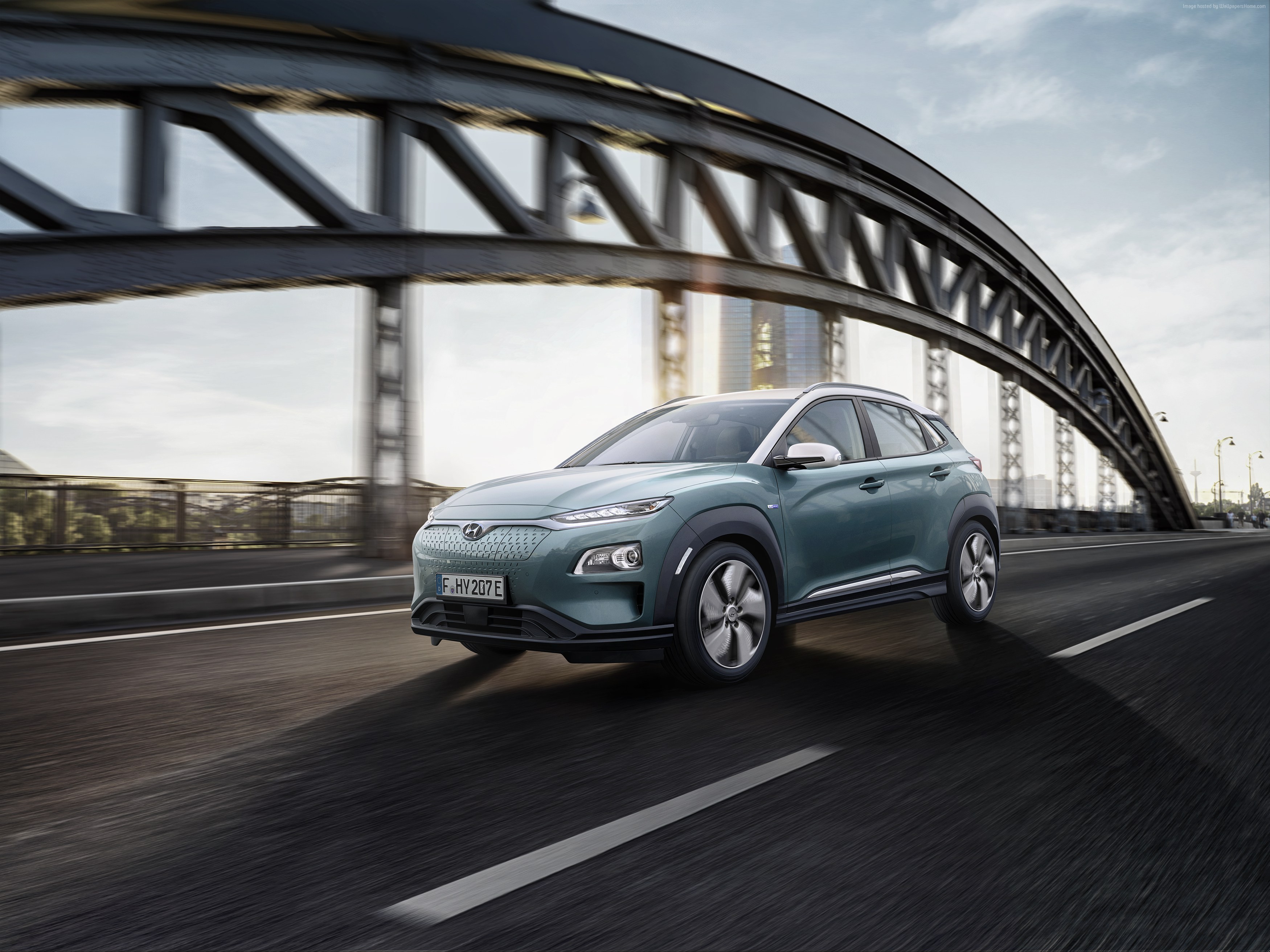 Hyundai Kona Electric driving on a bridge HD Wallpaper
