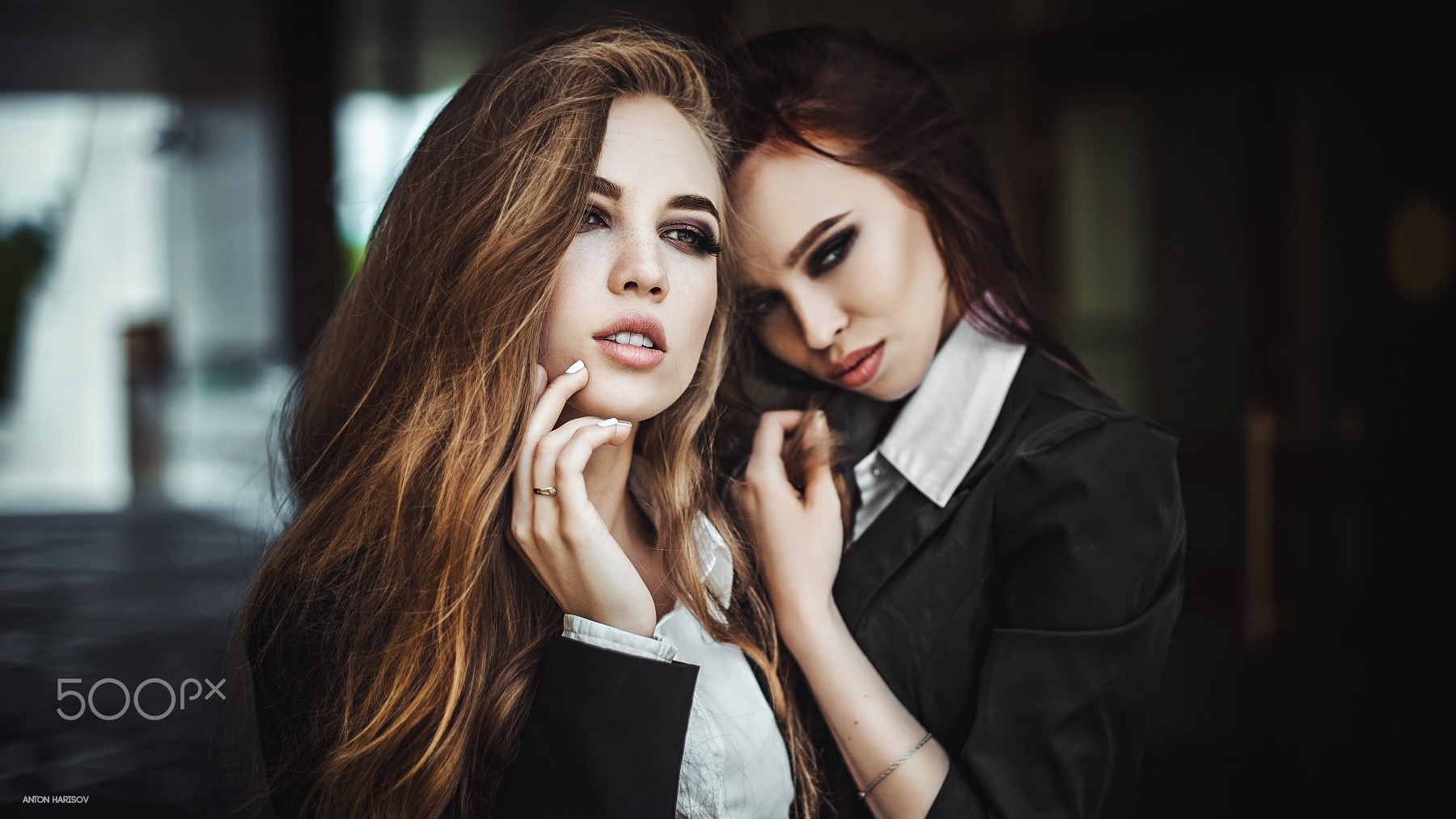Two women in suits posing for a photoshoot HD Wallpaper
