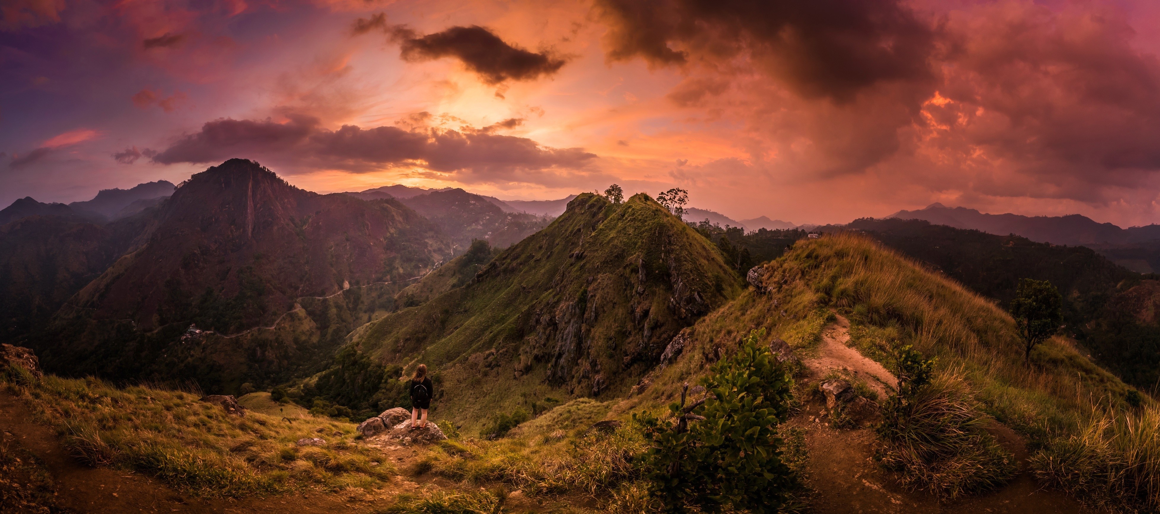 Person on a mountain ridge at sunset HD Wallpaper